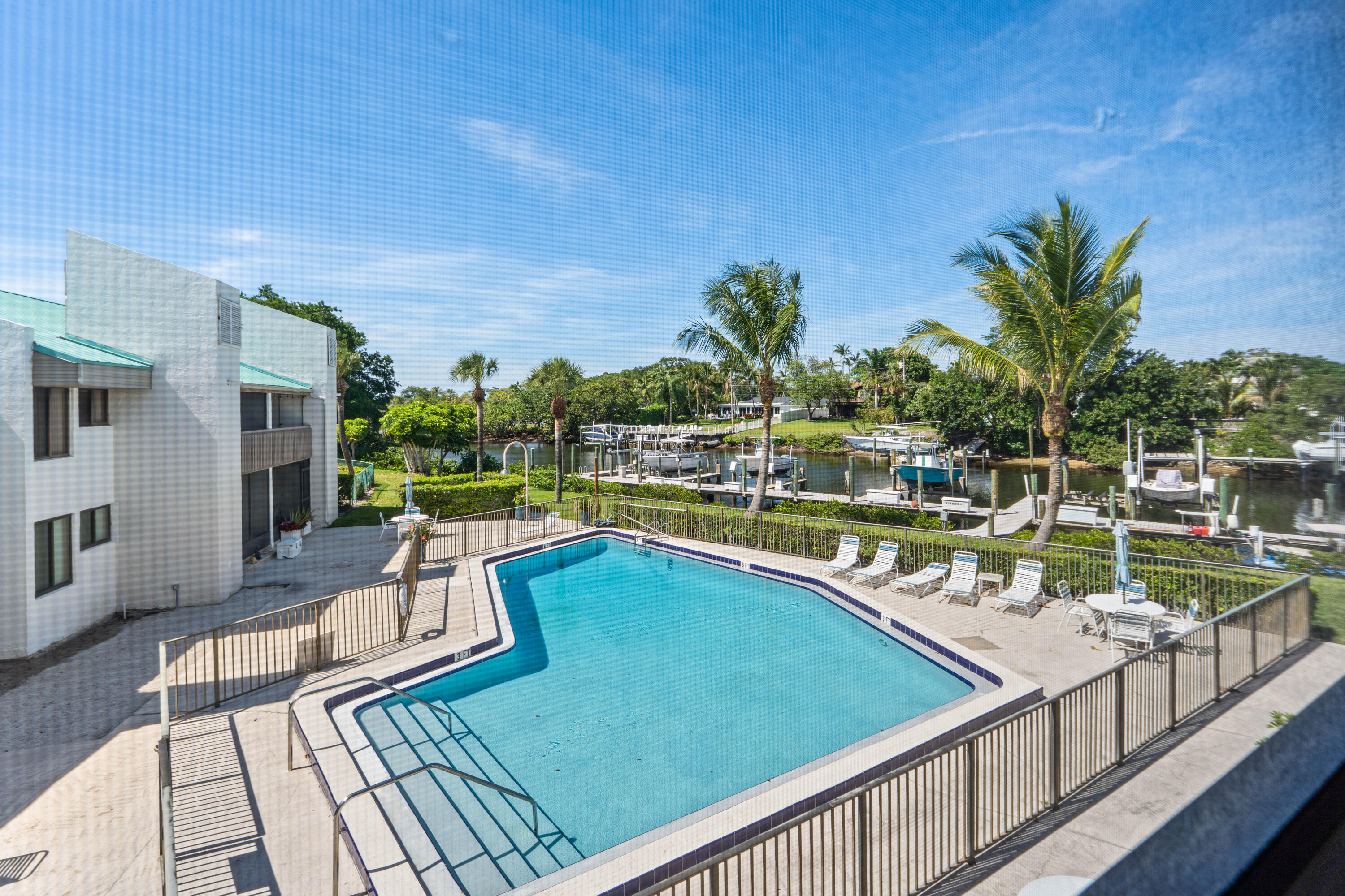 Newly remodeled 2/2 waterfront North Palm condo available on the Earman River. Impact windows + slider doors + front door with blinds, vinyl and tile throughout, remodeled bathrooms, knockdown ceilings, updated lighting, soft close cabinets and drawers, and quartz countertops. All appliances updated including black stainless kitchen appliances including in-range air fryer, new AC, tankless hot water heater, and washer & dryer.  Quiet community, screened in rear patio with river view and storage unit, front patio with room for a grill, plants and more, and additional view of river, paddleboard/kayak storage and stairwell for launch.