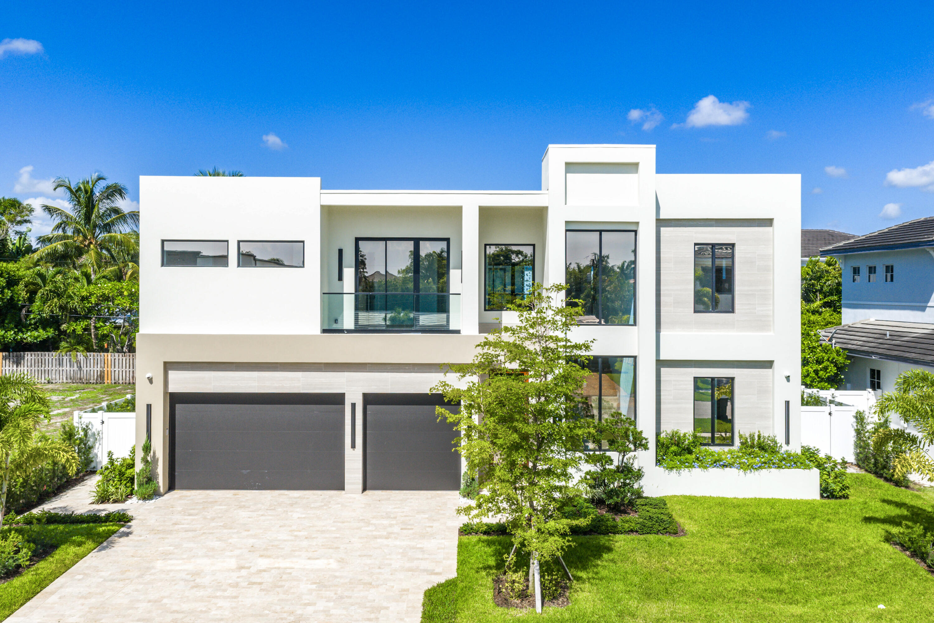 Welcome to 1031 NE 3rd Avenue, a newly constructed residence in the highly sought-after Boca Villas neighborhood, crafted by Skymar Custom Homes. This modern home sits on a 108' x 80' lot and offers a seamless blend of design, function, and location.

The main level features an open-concept layout with a chef's kitchen highlighted by a 9.5' x 11' island, custom two-tone cabinetry, paneled Thermador column refrigerator and freezer, dual-gas and electric range, wall speed oven, built-in coffee maker, and walk-in pantry with secondary laundry. Living and dining areas flow naturally into the clubroom with a wet bar and designer finishes, along with a flexible office or guest suite. Smart home technology includes Control4 lighting and automation, Sonos sound system, security cameras and landscape lighting. The backyard is designed for entertaining with a covered patio, oversized pool with sun shelf, spa with cascading waterfall, and a grassy area.

Upstairs, a loft with balcony access separates the guest bedrooms, each with en-suite baths, and a full laundry room. The primary suite offers two spacious walk-in closets and a spa-style bath featuring a glassless wet room with dual rain shower heads, multiple sprayers, and an oversized soaking tub.

Ideally located in East Boca, this home is just minutes from Mizner Park, The Boca Raton Resort & Club, beaches, dining, and downtown.