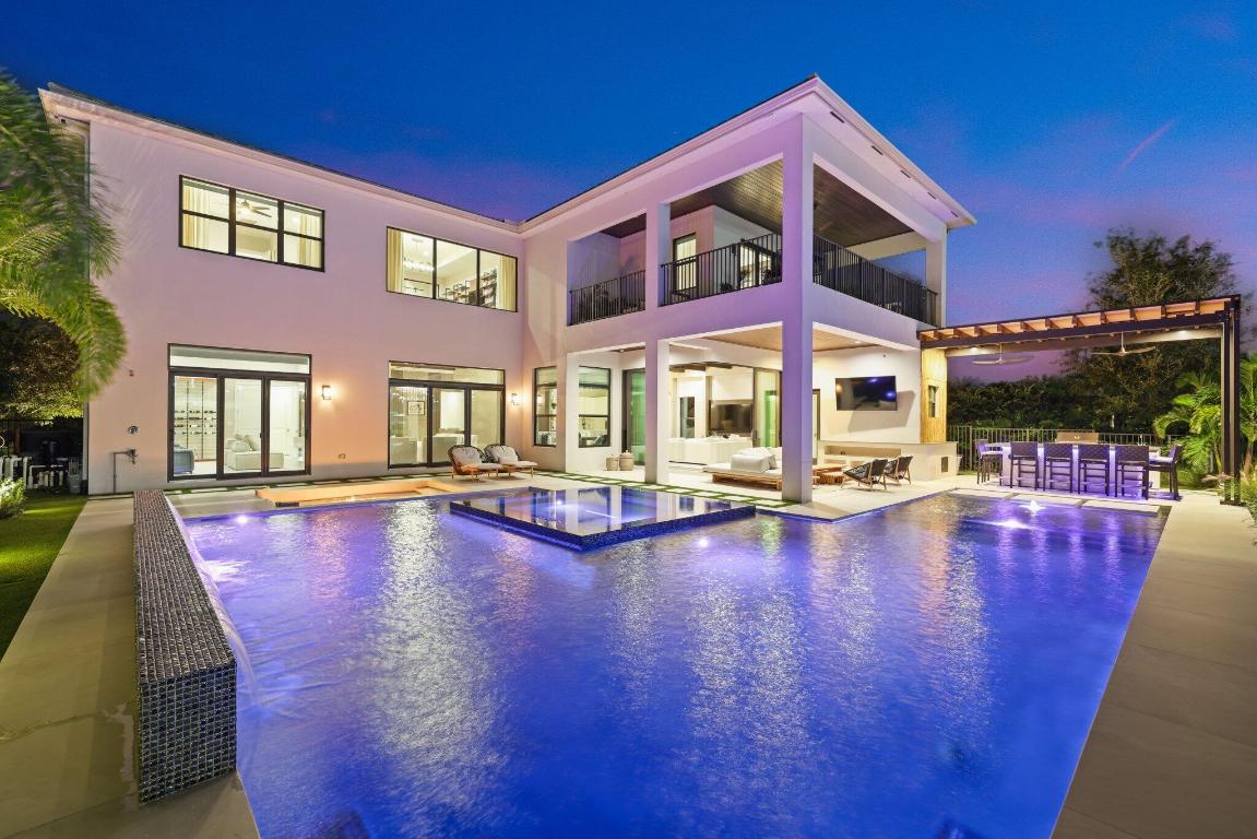 This highly upgraded, elegant estate in the sought-after Boca Bridges community offers over 6,000 square feet of living space, featuring 6 bedrooms, 7.5 bathrooms, and a sophisticated design throughout. The home showcases a gourmet chef's kitchen with sub-zero and Wolf appliances, a spacious master suite with a spa-like bathroom, and an expansive living area leading to a private outdoor oasis. Enjoy a covered patio, sparkling pool, and tranquil lake views. Boca Bridges provides resort-style amenities, including a clubhouse, fitness center, and tennis courts, all within a secure, gated community.