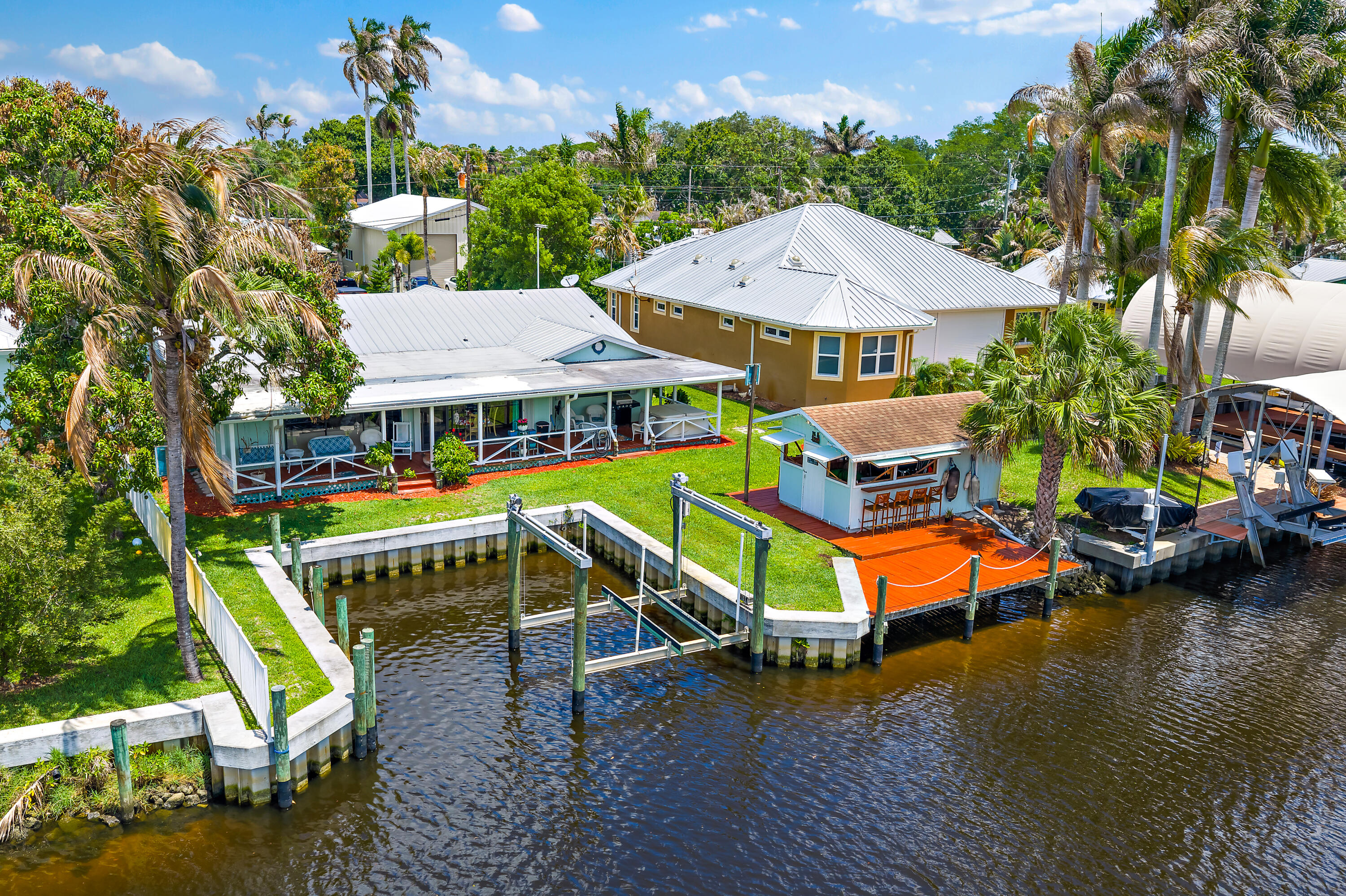 Tucked away in one of Stuart's hidden waterfront communities just off the St. Lucie River, this private waterfront home offers low HOA fees, limited restrictions, and the boating lifestyle buyers are searching for. The flexible split floor plan offers spacious living, a dedicated office, flex space, fireplace, and water views from the main living areas. Outside features include a new vinyl seawall with concrete cap, protected cut-out basin dockage, 16,000-lb boat lift, hot tub, and waterside entertaining area. No fixed bridges with quick access to the St. Lucie River. Conveniently located near Downtown Stuart, beaches, dining, shopping, marinas, golf, and I-95.