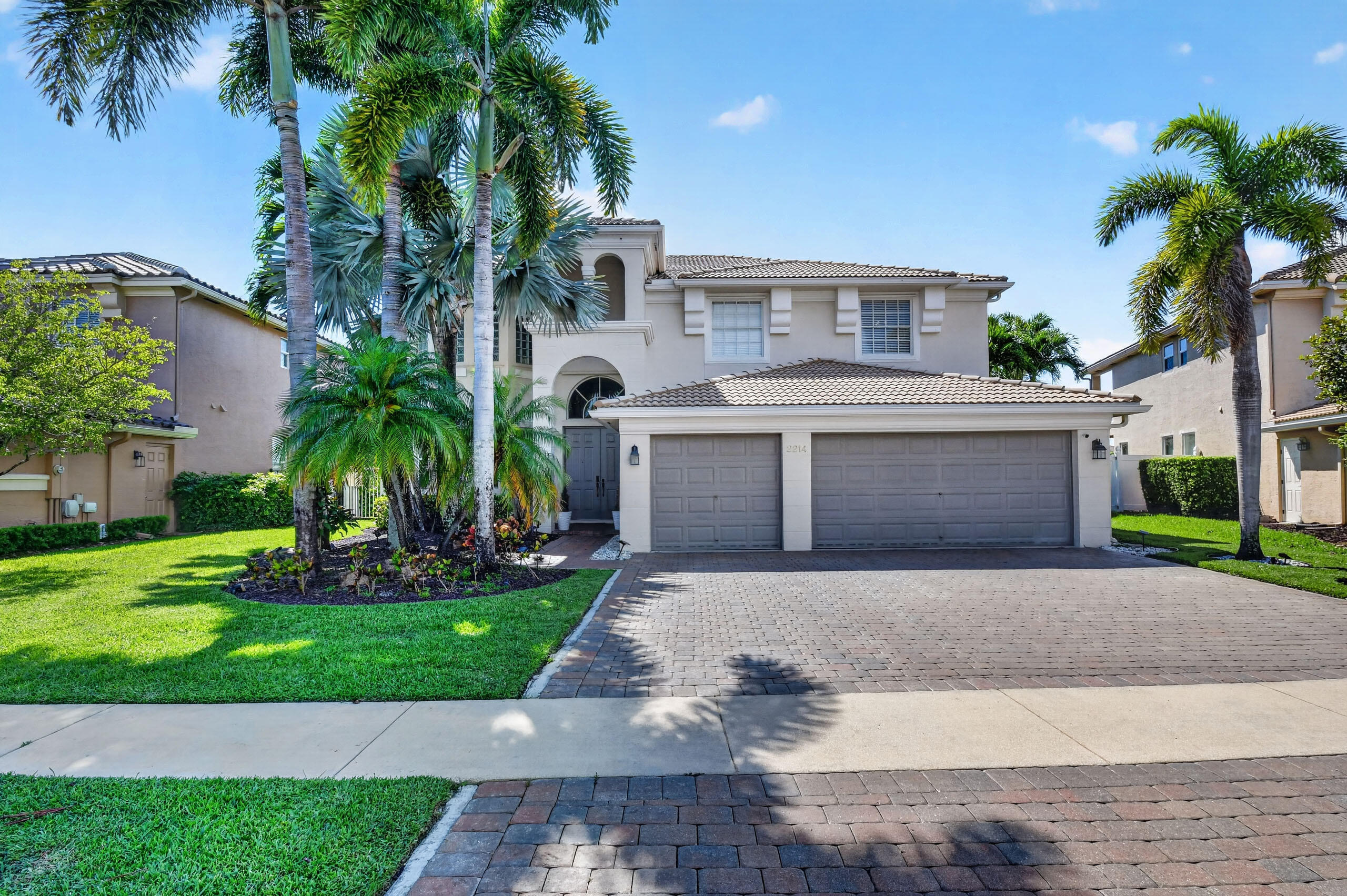 Welcome to 2214 Ridgewood Circle — an exceptional lakefront estate in the prestigious Madison Green community of Royal Palm Beach. This stunning 5-bedroom, 4-bathroom, 3,496 SF/AC home offers the ultimate Florida lifestyle, featuring breathtaking lake views, a personal pool, and a spacious 3-car garage. The upgraded kitchen features newer cabinetry, granite counters with a center island, and newer appliances.  Thoughtfully designed with mechanical accessibility to the second-story primary bedroom. This home blends luxury, comfort, and livability in perfect harmony.  The grand primary 2nd-story bedroom is a true retreat reached by a grand staircase. It boasts two private and separate en-suite bathrooms — an extraordinary feature ideal for couples or as a personal living benefit.  This suite also offers French-door access to a grand balcony overlooking a glorious lake and golf-view property.  Generously sized 2 secondary bedrooms on the upstairs level and one full bath provide ample space for guests. Engineered wood flooring enhances the richness of all the bedrooms on the second story. The 5th guest bedroom is on the main level, which can serve as an office or study. Step outside to your private backyard oasis, where grand lake views serve as the backdrop for the sparkling pool — perfect for entertaining or unwinding in the warm South Florida sun. Located within one of Palm Beach County's premier communities, Madison Green offers resort-style amenities including a clubhouse, fitness center, community pool, tennis and basketball courts, including a non-equity public golf course with pro shop — all delivered with value-priced HOA fees. Conveniently situated just minutes from top-rated schools, shopping, dining, the Florida Turnpike, and Palm Beach International Airport. This is more than a home — it's a lifestyle.   Schedule your private showing today. ________________________________________