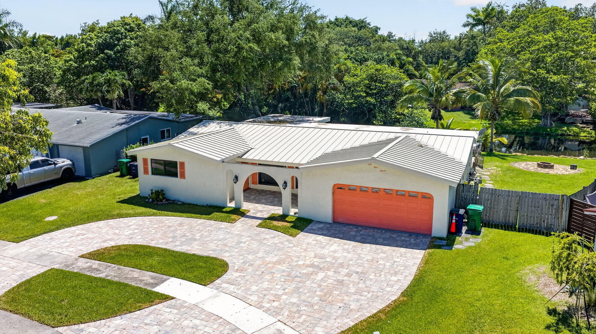 Cooper Estates Waterfront Pool Home! This 4-bedroom, 2-bathroom home sits on an oversized waterfront lot in sought-after Cooper Estates with no HOA. Recent upgrades include a brand-new metal roof, impact windows and doors, and new carpet in the bedrooms. The spacious backyard is designed for South Florida living, featuring a private pool, expansive green space, and canal frontage with peaceful water views. Inside, natural light fills the living areas, while large sliding glass doors create a seamless connection to the outdoor entertaining space. Conveniently located near major highways, shopping, dining, parks, and top-rated schools, this property offers the perfect combination of updates, location, and outdoor living.