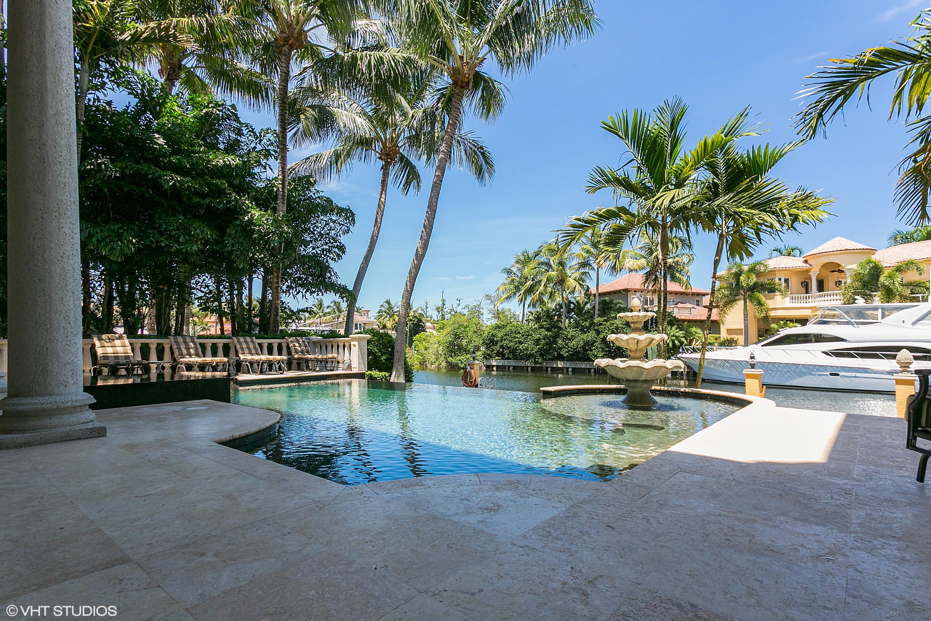 Builders own Custom Estate on over 111ft. of waterfront offers a private dock with access to the Intracoastal. This home has been renovated in the Transitional Style with Jerusalem flooring,freshly painted & rounded columns as you walk in to a magnificent living room & dining room overlooking the infinity edge pool & negative edge spa. Enjoy this home inside or outside with an outdoor entertainment center with sitting area to watch TV, sit by the new fireplace or watch the yachts go by. Spacious Updated Gourmet kitchen, new quartzite countertops with a large island for cooking. Family room & eat in kitchen, a bar for entertaining & a walk in wine cellar for the wine connoisseur. A wrought iron staircase leads you to the Owners Suite, sitting area & private balcony overlooking the canal. The buyers will love this magnificent master bedroom closet & a stunning master bath. There are also 3 suites on this floor along with loft for entertaining. Impact glass, a home generator, newer water heater, updated A/C units, 3 car garage & a first floor den/ office complete this waterfront estate.