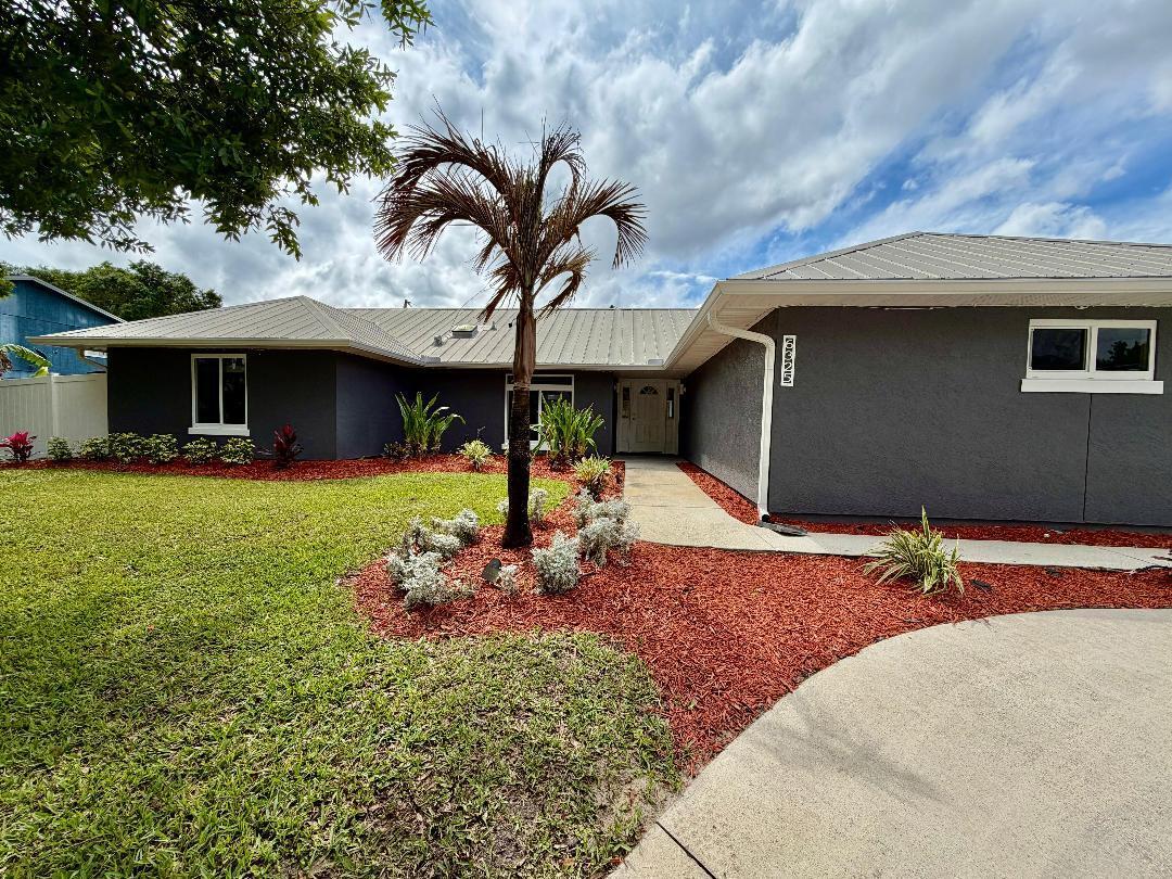 Welcome to your private Vero Beach retreat on a quiet, dead-end street with no HOA. This upgraded 3-bed, 2-bath split floor plan offers 1,828 sq ft on a 1/3 acre fenced lot. Cathedral ceilings, granite kitchen with stainless appliances, and remodeled baths including a spa-style primary suite with soaking tub, walk-in shower with steam system. Features include impact windows, metal roof, whole-home generator, and smart-home upgrades. Enjoy a 14×28 pool, covered patio, fire pit, tropical landscaping, 16 x 10 shed, and space for RV or boat parking—minutes from shopping, dining, and the beach.