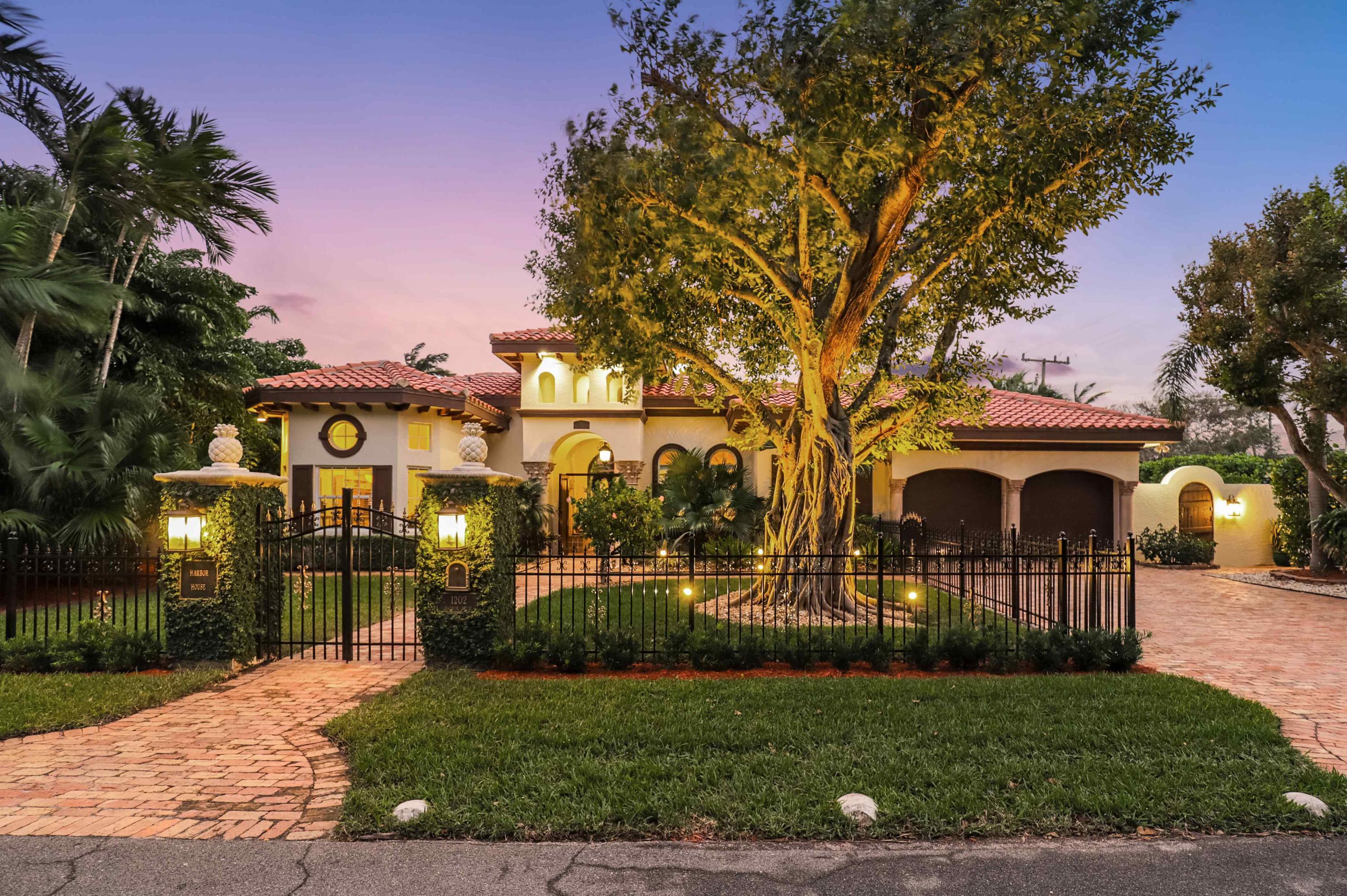 Are you ready to escape to your Tuscan sanctuary set in a private walled garden courtyard just 2 blocks from the ocean? Built by nationally recognized interior designer Lillian August as her personal vacation home, this SINGLE-STORY residence lives like a boutique resort hotel, taking indoor/outdoor living to a completely new level. A storybook castle door leads through an archway complete with wall fountain welcoming you to your private tropical oasis. The 15,000 sq ft corner lot provides a HUGE outdoor living area with a heated spa, pool with spillover, rock waterfall fountain, Chicago brick patio, sumptuous outdoor party room Located in coveted North Beach area, you'll love being just a 2-minute golf cart ride to downtown Delray's vibrant Atlantic Avenue. For more details, click 1202 HARBOR DRIVE, DELRAY BEACH

LOCATION: This home is located between the Intracoastal Waterway and the Atlantic Ocean a few blocks north of Atlantic Avenue. Marina Delray is in close proximity and access to I-95 is a short drive. You are centrally located 6 miles from Boca Raton Airport which has a U.S. Customs & Border Protection for international travelers, 16 miles to Palm Beach International Airport, 27 miles to Fort Lauderdale-Hollywood International Airport and 54 miles to Miami International Airport.

FEATURES:
Inside this single-story residence, you will be met with honed 24" marble floors, elegant archways magnificent custom millwork, plantation shutters, solid core doors and windows galore.

The large "formal" living room is currently used as a "fun room" that is large enough to accommodate pool table, full bar, game table and couches. No need for drapery on this room's numerous Palladian windows as abundant foliage provides the utmost privacy giving you a sense of being outside while staying comfortable in your air-conditioned space. French doors lead to an outdoor living room. With its pecky cypress ceiling, charming archways and adjacent rock waterfall, this unique "room" will be the center of your outdoor entertaining.
French doors also open to a unique office with two built-in marble desks and custom bookcases, file and storage cabinets.  If you work at home, you will absolutely love this office!
The kitchen is a Chef's Delight with everything you need at your fingertips. Raised panel cabinets with rope and dentil molding, gas range, Samsung French Door Refrigerator with middle drawer, 30" built-in wall oven and microwave and an oversized hammered copper "country" sink. The long, outward facing buffet-snack bar opens to the family room which has a built-in entertainment center. (Note if you remove the entertainment center, it has the same marble flooring under it.)
The sumptuous formal dining room features custom millwork accents and a large "sunburst" window overlooking the courtyard gardens and water features.
Master suite features his and her separate baths and two walk-in closets with extensive custom storage cabinetry. The bedroom has beautiful marble flooring. "Her" opulent bathroom has exquisite lighting fixtures and a Jacuzzi brand jetted tub, along with beautiful onyx countertops and Jerusalem stone flooring. "His" bathroom has its own shower and has marble countertops and flooring.

In the main house, totally separated from the master suite, you will find two additional generous-sized bedrooms with hard wood bamboo floors, along with a full bath with a shower. One of the bedrooms has a pair of French doors which opens to the courtyard.
Across the courtyard you will find a two-room guest house/cottage with full bath and kitchenette A perfect in-law suite, studio or private residence for your grown children/grandchildren or guests.
The large inside laundry room has newer LG Steam washer and dryer plus extensive storage cabinets and hanging racks.
Audiophiles will enjoy the SONOS system with speakers throughout the home and outdoor living areas. There is also extensive LED lighting.

In the 456 square foot expanded two-car garage with new custom cabinets you will find a staircase and dumb waiter that leads to a stand-up, air-conditioned, whole-house attic complete with numerous storage shelves.
.
Natural gas powers the appliances including the oversized water heater and whole house Generac 22kw generator. No need for a buried generator gas tank or BBQ propane tanks. The whole house generator and impact glass windows provide comfort and peace of mind during hurricane season.

The fully fenced yard is surrounded by 15-20 ft hedges and areca palms lending a private compound-feel to this unique estate home. Security system includes a Ring Doorbell, motion detectors, security lighting on timers. 
You can swim year-round since the 40' x 20' pool has both electric and natural gas heating systems.
The side yard has a separate outdoor dining area with built in barbecue. There is a separate fenced area that is a perfect dog run. This home even includes a SOLO electric doggy door for your furry friends. Never rush home to "let the dogs out" again.
You'll appreciate the mosquito deterrence system (chrysanthemum spray) encircling the courtyard as well as the landscape irrigation system run off of the City of Delray Beach Reclaimed Water Program.

Note: Dining room lighting fixture and wine cooler are excluded. House has central vacuum system but current owners have never used it and it is not warranted. Safe in office will convey to buyer.
