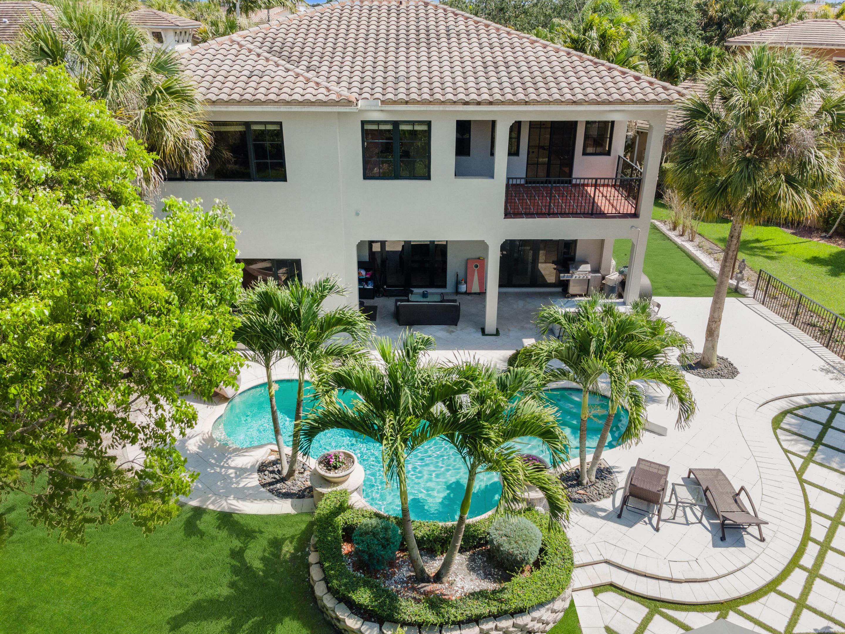 Located on one of PGCC's most desirable cul-de-sac streets, this exceptional estate is offered for sale or lease. Designed for both everyday comfort and upscale entertaining, the home features expansive living spaces and seamless indoor-outdoor flow throughout. A custom bar creates the perfect atmosphere for hosting guests, while the resort-style backyard offers a sparkling pool, covered pergola and outdoor putting green for year-round South Florida living. Additional highlights include a spacious family room and outstanding curb appeal. The home also includes a complimentary one-year One Home Concierge membership featuring a home warranty, AC maintenance, a preloaded iPad with home documents and maintenance history, and access to the top 2 local companies.