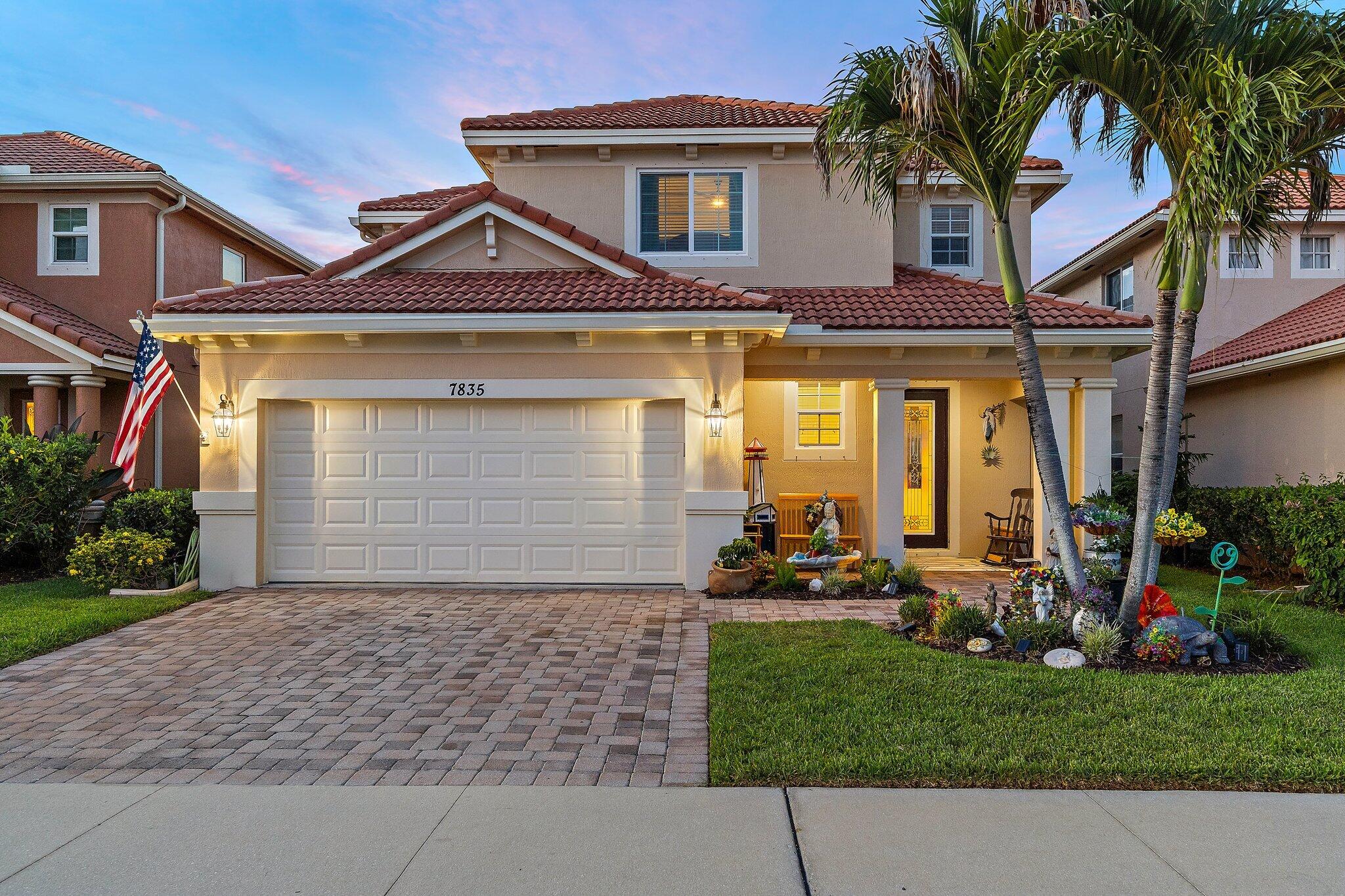 Imagine starting each day with tranquil lake views and sunlight streaming through soaring ceilings in this stunning 4-bedroom, 3.5-bath lakefront home located in the sought-after Oaks of Hobe Sound. From the moment you enter, you'll be welcomed by an open, airy floor plan filled with natural light. Dramatic 20-foot ceilings and expansive windows create a bright and inviting atmosphere, while wood-look porcelain tile flooring throughout the main level offers both elegance and durability for effortless Florida living. At the heart of the home, the gourmet kitchen is designed for both everyday living and entertaining, featuring quartz countertops, newer black stainless steel appliances, double wall ovens, 42-inch wood cabinetry, and a spacious center island perfect for gatherings.  The spacious first-floor primary suite is a private retreat, featuring French doors that open to the covered lanai and showcase beautiful lake views. Upstairs, a generous loft provides versatile living space ideal for a media room, home office, or playroom, along with three additional bedrooms, including a private guest suite with its own full bath. Step outside to your own backyard paradise, where eastern exposure over the lake creates the perfect setting to enjoy morning coffee while watching the sunrise. In the evenings, the home's orientation helps keep the outdoor living areas comfortable, making it an ideal place to dine al fresco and relax under the stars. For added peace of mind and energy efficiency, the home is equipped with impact windows and accordion shutters.  Located within the gated community of The Oaks of Hobe Sound, residents enjoy an exceptional lifestyle with lawn care, cable, internet, a resort-style pool and spa, playground, and secure gated entrances—all with low HOA fees.  Conveniently situated just minutes from Hobe Sound Beach, the Jimmy Graham Boat Ramp and kayak launch, Gomez Preserve's scenic nature trails, and the charming shops and restaurants of downtown Hobe Sound, this home offers the perfect combination of privacy, convenience, and the best of Florida living.