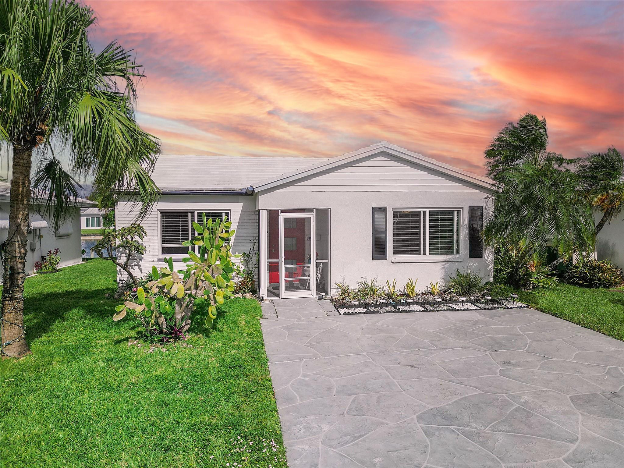 This beautiful 2-bedroom home boasts stunning waterfront views, a bright sun lit interior with an abundance of natural light, and modern finishes throughout! Enjoy peace of mind with full hurricane protection provided by ALL IMPACT WINDOWS and doors. The interior features newer vinyl flooring throughout, updated kitchen with granite counter tops, and stainless steel appliances, creating a modern space perfect for relaxing or entertaining. Spacious laundry room could easily be converted to second bathroom offering the potential for added value. Situated in a vibrant 55+ community, this home offers access to a clubhouse, community pool, and a serene lifestyle by the water with a low HOA of only $88 a month.