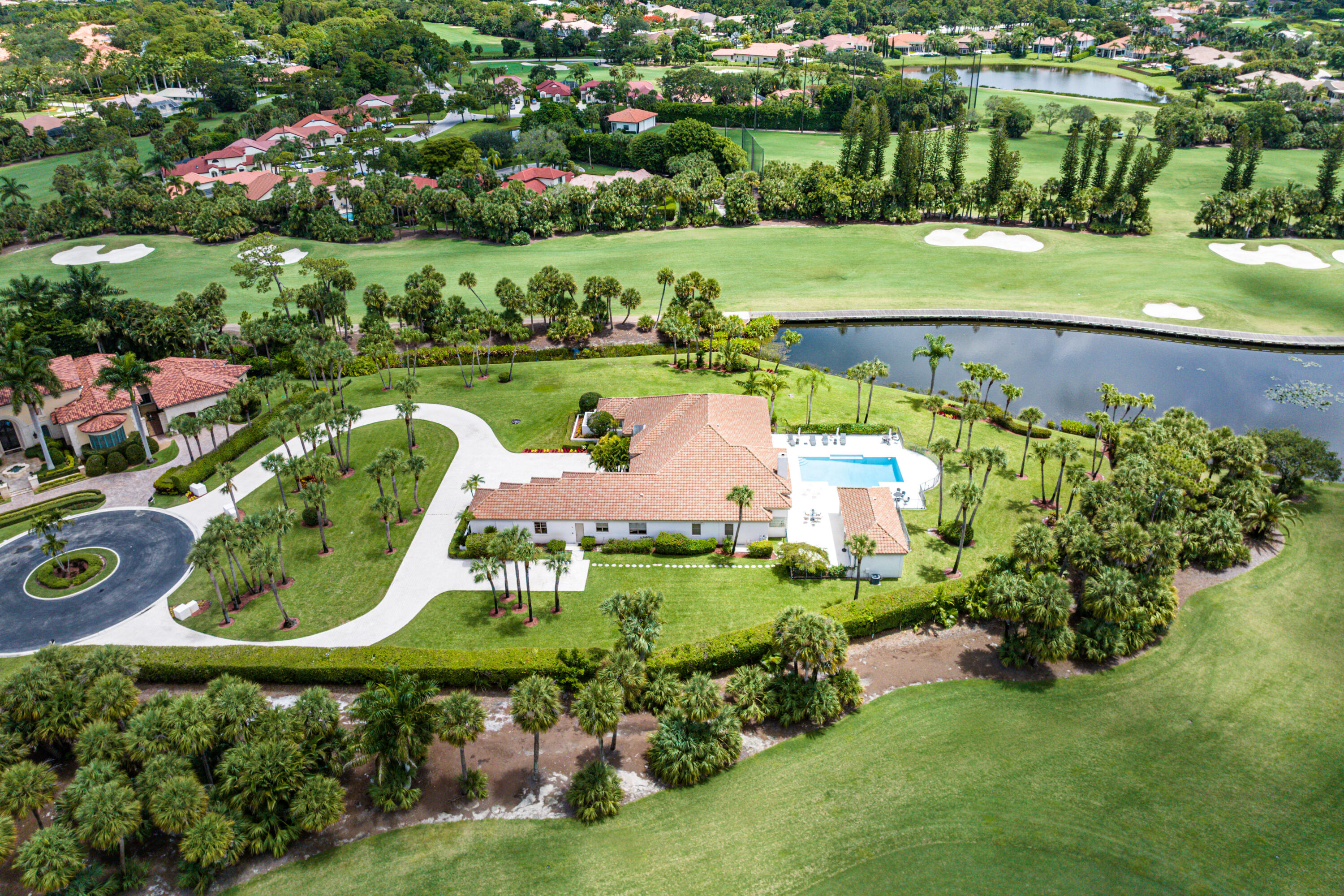 This one of a kind luxury Mediterranean Estate home is located in an Island Paradise, The ENCLAVE, a dual gated community of eight luxury custom estates, nestled within Exclusive Breakers West. The estate sits on approximately 1.5 waterfront acres and the sixth hole of the Breakers West Rees Jones golf course. The architectural design is of the highest standards throughout featuring two custom stone fire places, hand detailed elegant coffered ceilings and crown molding trim, and imported marble flooring abounding throughout. This home has 5,176 sq. ft. of living space, a gourmet kitchen with all high end Miele appliances, five bedrooms and 5.5 baths, including a private guest house, a resort style pool and entertaining area, four car garage and the most impressive circular drive in BW.