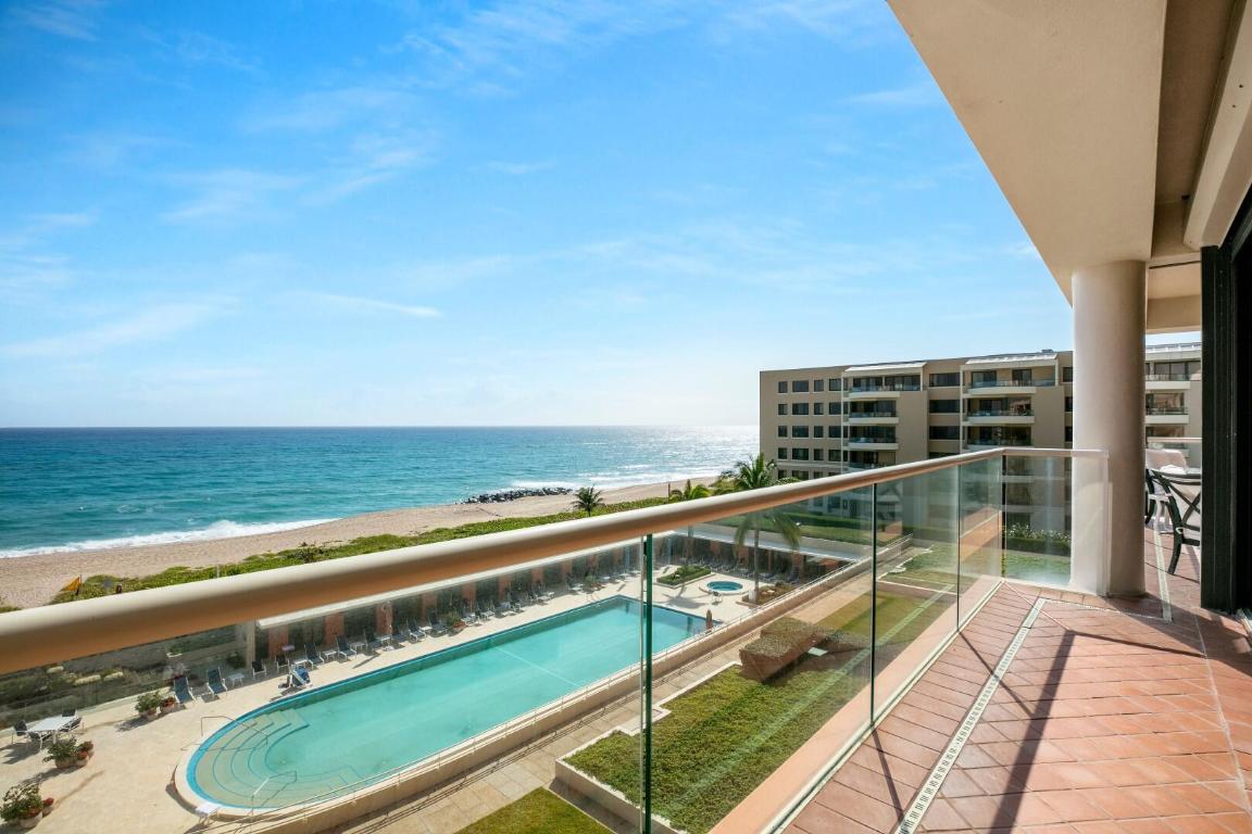 Oceanfront Breakers Row 2BR/2.1BA plus library  condominium with poolside cabana. Beautiful corner unit features spacious and light filled great room with floor to ceiling windows. Multiple open balconies and a fantastic covered balcony with incredible sunrise, ocean, and pool views. Additional highlights include large owner's suite, kitchen with butler's pantry, and laundry room. Two North Breakers Row is a full service building with on-site manager, manned guard house, resort style pool area, Pilates room, and weight training room.