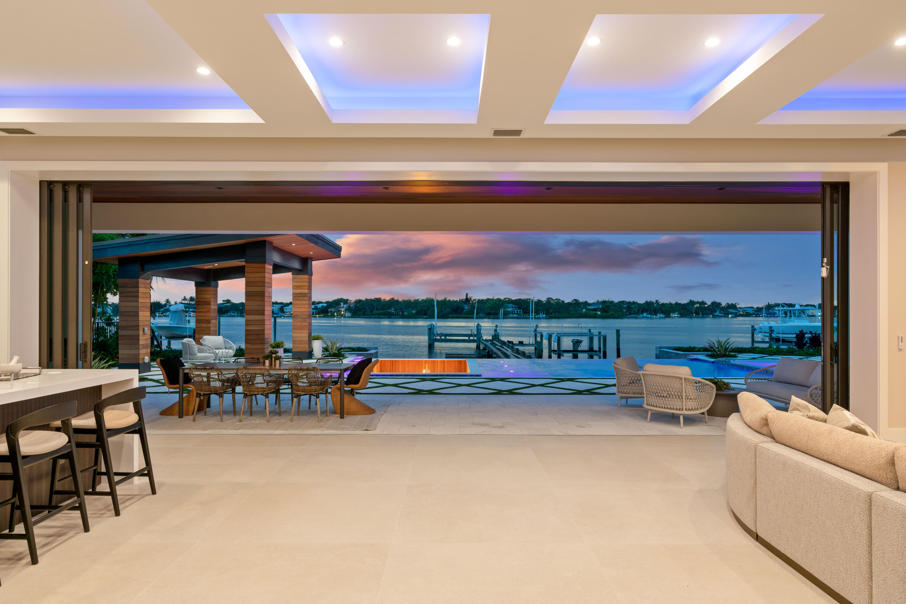 BRAND NEW MOVE IN READY custom waterfront residence on prime wide river frontage with direct ocean access! Bring your watercrafts and enjoy 100 feet of wide water views with brand new custom seawall, 3 separate boat lifts and a pristine dock! The epitome of South Florida luxury living with saltwater pool, sun deck, spa, sunken fire pit and poolside cabana as well as summer kitchen and covered and open balconies. Impressive interior with Chanel-inspired kitchen and baths, versatile floor plan including 5 bedrooms with 2 primary suites, 7 full baths, 6th/club room and study. Dual temperature-controlled garages with ample volume for lifts. Smart home features allow for easy automation of security, sound, pool and more! Tequesta Country Club membership options available but not mandatory.