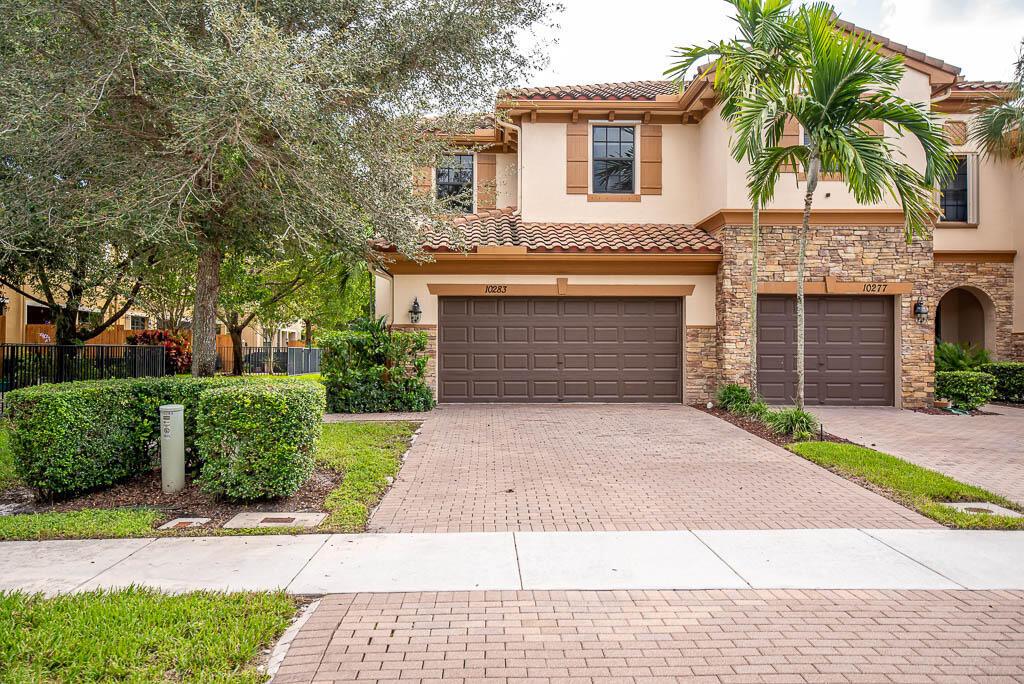 Fabulous waterfront 4 bed/3 ba townhouse with a 2 car garages. GATED COMMUNITY & built in 2015. 1 bedroom downstairs, great for guest or in-laws. And 3 bedrooms upstairs including the master bedroom. Great location, close to the community pool. Nice corner lot with a fabulous lakeview and beautiful upgrades. Stainless steel appliances, cherry wood cabinets, granite countertops and full tumbled marble backsplash. Tiles throughout the living area and NEW neutral color carpet in bedrooms. Large laundry room. Enjoy sitting out on your covered patio overlooking the beautiful water view! Electronic gated community and has its very own community pool * Close to Wellingtons ''A'' rated schools, Trader Joe's, polo, etc.. NO PETS ALLOWED