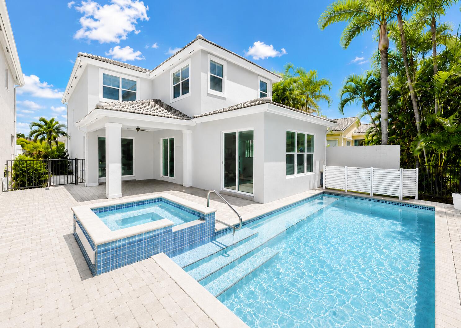 Welcome to this beautiful completely updated pool home located in the highly desirable gated community of Mirabella at Mirasol in the heart of Palm Beach Gardens. Offering 4 bds, 2.5 baths & approximately 2,344 square feet of living space, this residence combines modern updates, comfortable living, and exceptional outdoor entertaining. Step inside to discover soaring 10-foot ceilings, approximately 8-foot interior doors, abundant natural light, and an open, flowing floor plan designed for both everyday living and entertaining. The updated kitchen features elegant quartz countertops, ample cabinetry, and a spacious layout that opens seamlessly to the living and dining areas. Sliding glass doors lead to a covered lanai overlooking the sparkling heated pool and private backyard, creating t he perfect setting for indoor-outdoor Florida living. The spacious primary suite offers a peaceful retreat with an updated bathroom, while the additional bedrooms provide flexibility for family, guests, or a home office. Additional features include a roof that is approximately 8 years new,  3 updated bathrooms, 2 glass sliders from Living Room, & Kitchen to covered lanai, 3rd slider to patio/pool area, and numerous upgrades throughout. Outside, paver driveway, covered front courtyard &  enjoy your own private oasis in rear yard complete with a heated pool, spa, covered patio, and lush tropical landscaping. Whether hosting gatherings or enjoying a quiet evening at home, this backyard is designed for relaxation and enjoyment. Residents of Mirabella enjoy a 24-hour manned gated entrance, resort-style clubhouse, state-of-the-art fitness center, heated community pool, tennis courts, playground, social activities, and beautifully maintained common areas, all with no mandatory golf membership required. The community clubhouse hosts approximately two social events each month, creating plenty of opportunities for neighbors to connect and enjoy an active lifestyle. Residents can look forward to a variety of fun, family-friendly gatherings, including food truck nights featuring live music and complimentary beer and wine. Throughout the year, the clubhouse celebrates holidays and seasonal occasions with special events such as Father's Day, Mother's Day, back-to-school celebrations, and festive holiday parties. Many events include attractions like inflatable water slides, petting zoos, games, and activities for children, making the community welcoming for residents of all ages and their visiting families. These thoughtfully planned events help foster a vibrant, engaging atmosphere where neighbors can relax, socialize, and create lasting memories together. Ideally located near top-rated schools, championship golf courses, The Gardens Mall, fine dining, world-class shopping, beautiful beaches, boating, fishing, Palm Beach International Airport, Downtown West Palm Beach, The Square, I-95, and Florida's Turnpike. Experience the best of Palm Beach Gardens living in one of the area's most sought-after communities.