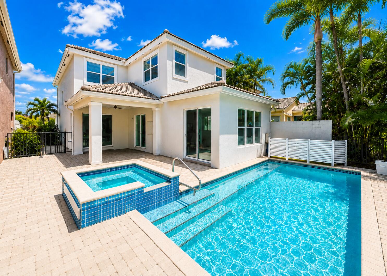 Welcome to this beautiful completely updated pool home located in the highly desirable gated community of Mirabella at Mirasol in the heart of Palm Beach Gardens. Offering 4 bds, 2.5 baths & approximately 2,344 square feet of living space, this residence combines modern updates, comfortable living, and exceptional outdoor entertaining. Step inside to discover soaring 10-foot ceilings, approximately 8-foot interior doors, abundant natural light, and an open, flowing floor plan designed for both everyday living and entertaining. The updated kitchen features elegant quartz countertops, ample cabinetry, and a spacious layout that opens seamlessly to the living and dining areas. Sliding glass doors lead to a covered lanai overlooking the sparkling heated pool and private backyard, creating t he perfect setting for indoor-outdoor Florida living. The spacious primary suite offers a peaceful retreat with an updated bathroom, while the additional bedrooms provide flexibility for family, guests, or a home office. Additional features include a roof that is approximately 8 years new,  3 updated bathrooms, 2 glass sliders from Living Room, & Kitchen to covered lanai, 3rd slider to patio/pool area, and numerous upgrades throughout. Outside, paver driveway, covered front courtyard &  enjoy your own private oasis in rear yard complete with a heated pool, spa, covered patio, and lush tropical landscaping. Whether hosting gatherings or enjoying a quiet evening at home, this backyard is designed for relaxation and enjoyment. Residents of Mirabella enjoy a 24-hour manned gated entrance, resort-style clubhouse, state-of-the-art fitness center, heated community pool, tennis courts, playground, social activities, and beautifully maintained common areas, all with no mandatory golf membership required. The community clubhouse hosts approximately two social events each month, creating plenty of opportunities for neighbors to connect and enjoy an active lifestyle. Residents can look forward to a variety of fun, family-friendly gatherings, including food truck nights featuring live music and complimentary beer and wine. Throughout the year, the clubhouse celebrates holidays and seasonal occasions with special events such as Father's Day, Mother's Day, back-to-school celebrations, and festive holiday parties. Many events include attractions like inflatable water slides, petting zoos, games, and activities for children, making the community welcoming for residents of all ages and their visiting families. These thoughtfully planned events help foster a vibrant, engaging atmosphere where neighbors can relax, socialize, and create lasting memories together. Ideally located near top-rated schools, championship golf courses, The Gardens Mall, fine dining, world-class shopping, beautiful beaches, boating, fishing, Palm Beach International Airport, Downtown West Palm Beach, The Square, I-95, and Florida's Turnpike. Experience the best of Palm Beach Gardens living in one of the area's most sought-after communities.