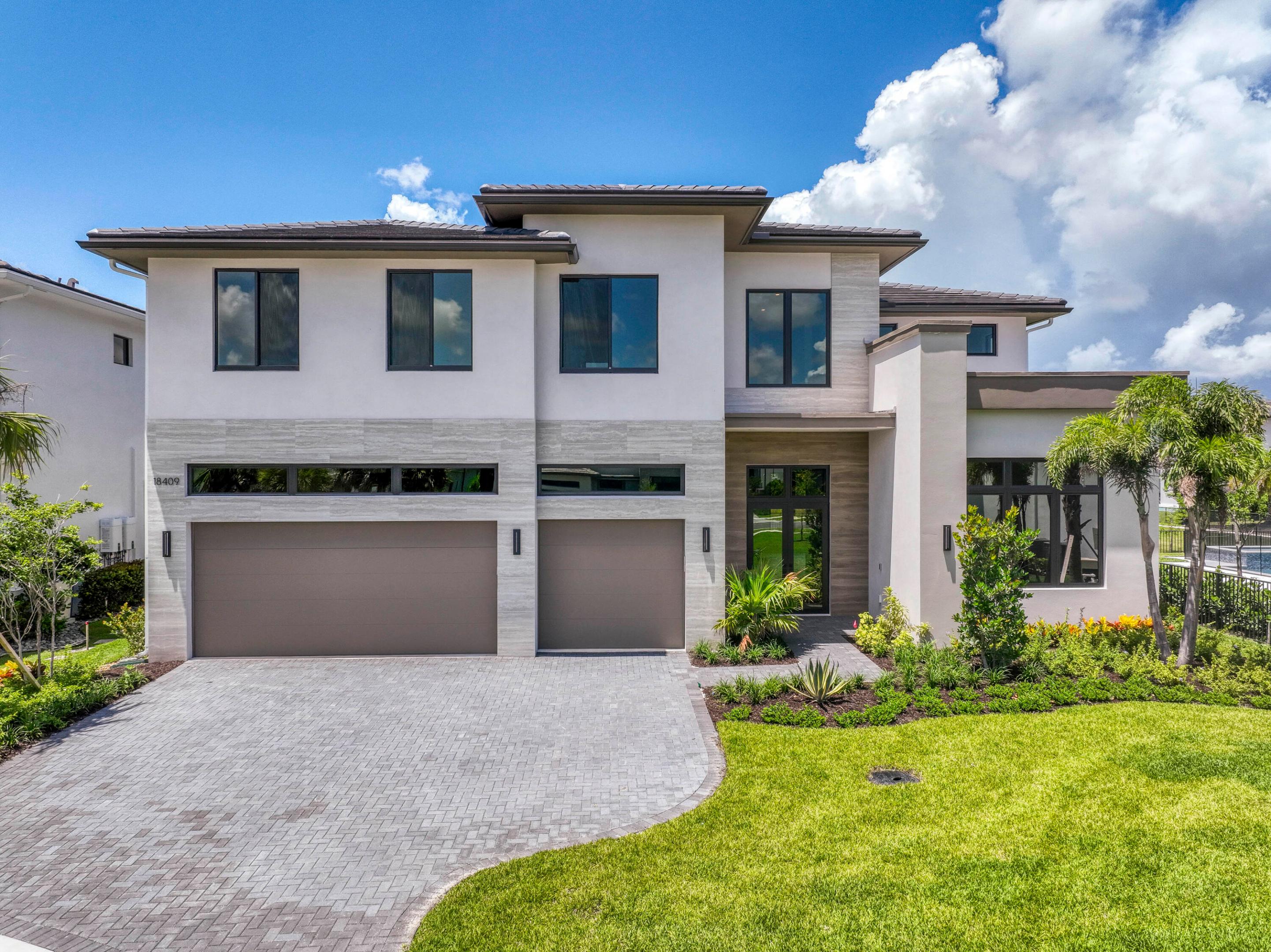 Brand new construction right in the heart of Jupiter, this stunning 6 bed, 6.5 bath, two-story home spans 4,906 sq feet of pure perfection. The attention to detail and seamless flow throughout are realized upon the moment of entry. Elegant and open, the main living area features 30' x 60' porcelain tiles in the main living area and 10 ft floor to ceiling sliders offering a dramatic indoor/outdoor living experience. The chef's kitchen features waterfall quartz countertops, tons of cabinet space, and top of the line Sub Zero and Wolf appliances. The ground floor primary suite boasts dual walk-in closets, separate dual shower and soaking tub, and beautiful porcelain tile extending from floors to ceiling. Upstairs you'll find a spacious bonus loft area along with sizable bedrooms. The backyard features a full summer kitchen as well as a sparking pool and spa, all surrounded by vibrant tropical landscaping. Symphony is Jupiter's one and only premier community featuring modern and contemporary new construction. A truly unbeatable location in the heart of Jupiter with easy access to the beach, restaurants, shopping, and natural preserve areas.