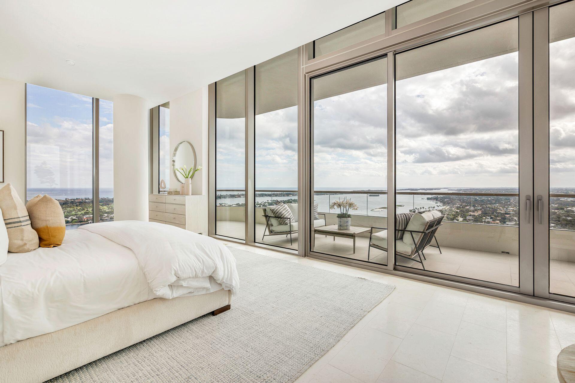 Perched high above S Flagler Drive, waterfront Penthouse G at La Clara lives like a house in the sky offering uninterrupted views of the Atlantic Ocean, Palm Beach Island, Intracoastal, and downtown skyline. A foyer with soaring ceilings leads into a lounge and formal living room framed by floor-to-ceiling water views. Vistas continue through the dining room to an expansive family room and gourmet kitchen, showcasing Miele appliances, gas cooktop, butler's pantry, and oversized island with seating. Designed for effortless indoor-outdoor living, the sprawling covered terrace flows seamlessly from the family room, creating an ideal setting for sunset cocktails, intimate dinners, or elevated entertaining with a panoramic backdrop. The luxurious primary suite offers complete privacy with... ...with a South-facing balcony and views stretching from East to West. Through a bonus den/office connects two private guest suites with ensuite baths. Additional features include a laundry room, powder room, storage space, and 3 premium garage parking spaces. Residents of La Clara enjoy world-class amenities, a state-of-the-art waterfront fitness center, resort-style pool, 24/7 valet, private cinema, and onsite guest suites - creating a lifestyle that is unmatched.