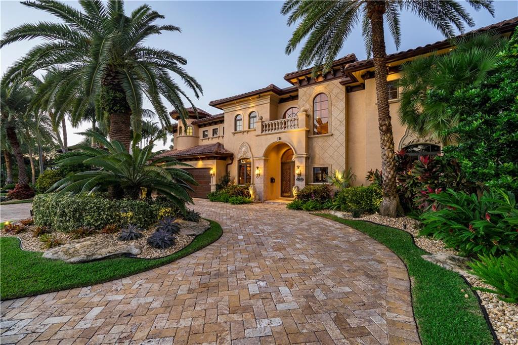 Impeccable Coral Ridge CC waterfront Mediterranean estate w/ 100’ dock, no fixed bridges w/ ocean access. Steven G interiors featuring Venetian finished walls, custom moldings/woodwork, gilded coffer ceilings & hand-blown Italian chandeliers. Savant home smart system controls nearly all from your phone. Climate-controlled wine cellar adjacent to an open gourmet kitchen w/ high-end appliances (gas range). Full summer kitchen/bar overlooks the heated pool/spa, waterfall, firepit and misters which is surrounded by mature landscaping designed for privacy. Work from home in a built-in partners office w/ large walk-in closet, then recline & binge-watch in your plush theater. Exceptional Master Suite featuring 2 large walk-in dressing rooms, backlit onyx/marble, steam shower & jacuzzi! Every inch of this home is designed for luxurious living and entertaining. Savant app can help manage your lighting, music, TV, shades, HVAC, & pool/spa/waterfall/misters. Feel secure w/ impact windows/doors, an alarm and camera system. 3 bay garage has granite tile floors, wall storage system, built-in shelving and Tesla electric charging station. Includes a central vacuum system, 21’ ceiling living room w/ fireplace, dining room w/ exquisite built -ins, a marble staircase or elevator can take you to the en suite bedrooms. New for 2019/2020: 3 HVAC units with UV lighting, Hybrid water heater, 2 LG washers/dryers, gas & electric pool heaters, exterior painted.