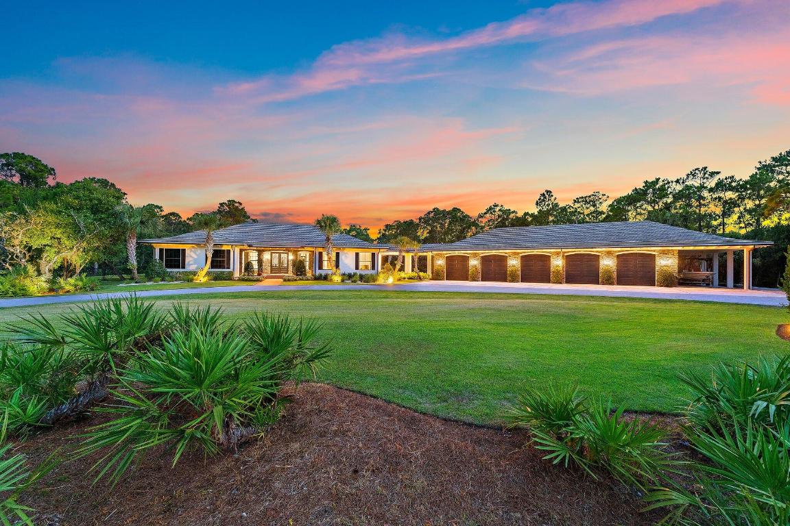 You may have heard it before, but THIS home is truly one of one. Situated in the heart of Jupiter in a private, gated sanctuary on over 5 acres is a 4-bedroom, 4.5-bathroom residence with office/flex room, theatre, game room and wine room. It was built in 2016 by renowned local luxury builder D&D Specialties. Touting 5,500 square feet of living space AND a 3,000 square foot, air-conditioned 10+ car garage complete with its own office and gym. Entertain guests or keep your skills sharp on your personal par three golf hole. Take a dip in the stunning pool with champagne hot tub and beautiful Ipe wood deck. Natural and manicured landscaping provides a dramatic approach and solitude from the outside world. Luxury, beauty and privacy, only minutes from everything the area has to offer.