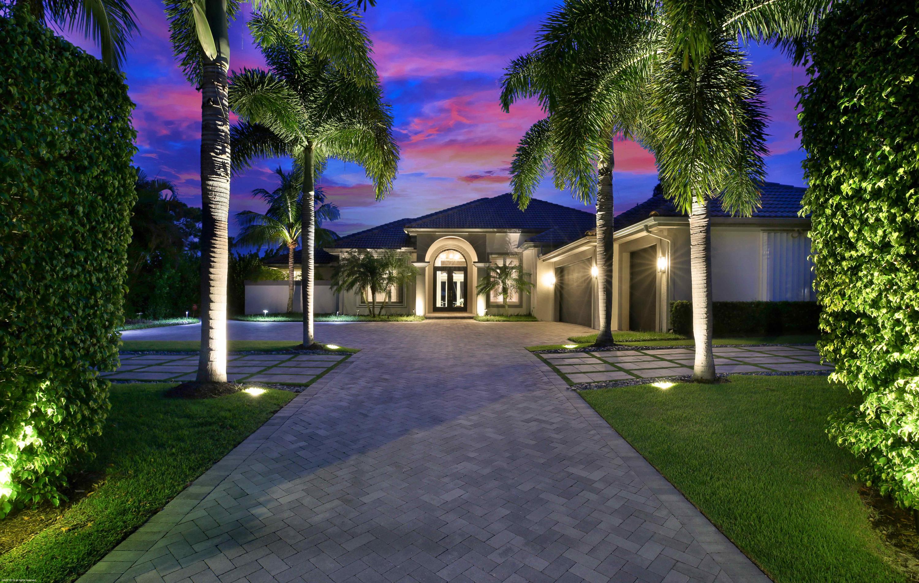 Absolutely stunning riverfront home with high-end, luxury finishes in the desirable Tequesta Country Club sitting on the widest part of the Loxahatchee River. This newly remodeled home is filled with modern flair. Enter through a dramatic foyer and behold the stunning water views surrounding the formal living room with imported marble encasing the floor-to-ceiling hearth. A luxury chandelier hangs from a designer ceiling and dazzles your guests in the waterfront formal dining room. Let the entertainment begin as you enter through custom floor-to-ceiling glass doors in the jewel of the home- the 300-bottle wine room with decanting/tasting lounge featuring hand-woven wallpaper.

The fully renovated chef's kitchen is a stunning gathering place with a 20ft wall of book matched Calacatta Gold marble, open shelving, Wolf/SubZero appliances, generous custom cabinetry with hidden coffee station, marble countertops, Kohler Carbon articulating faucets, and wet-bar w/ ice maker. Greet the morning in the family sized-breakfast nook with custom banquet seating. The magnificent master bedroom is surrounded by his/her baths with floor-to-ceiling marble, curbless walk-in showers, floating cabinets, and Kohler Purist Brushed Gold fixtures. His/hers custom closets have digital locks. All bedrooms with ensuite baths. The laundry has a floor-to-ceiling custom storage area.

A spacious 3-car air conditioned garage. Newly renovated exterior includes an expanded brick driveway, professional landscaping with outdoor lighting, generator, hurricane windows & accordion shutters, Halo 5 water treatment system, new infinity edge, salt chlorinated pool with Hayward Omni logic automation, propane heater, sun shelf, new backyard patio/pool deck equipped with summer kitchen, Restoration Hardware Topanga fire pit, privacy fencing & gates, newly engineered & built concrete seawall and a new dock with 16,000lb boat lift, dock box & piling wraps, LED lighting make this the perfect home to entertain in, South Florida Style!!!