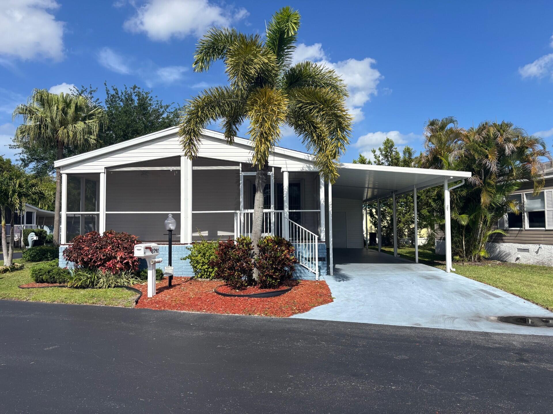 BEAUTIFUL CORNER HOME, WELL MAINTAINED WITH 2 BEDROOMS, 2 BATH'S AND LARGE ENCLOSED PORCH OFFERING GREAT CONFORT AND SERENITY.  IT HAS ALL THE SPACE FOR RELAXATION AND DELIGHTFUL. CENTRAL AIR AND APPLIANCES ARE ONLY 6 YEARS OLD, SHINGLE  ROOF 8 YEARS OLD.  LOCATED IN A 55+ COMMUNITY, ONLY A FEW MILES TO THE DESIRABLE BEACH OF DEERFIELD, THE WORRY-FREE SOUTH FLORIDA LIFESTYLE, WITH AMENITIES TO GALORE. CALL TODAY! IT WON'T LAST!!! LOT RENTAL $1,062.71 MONTLHY