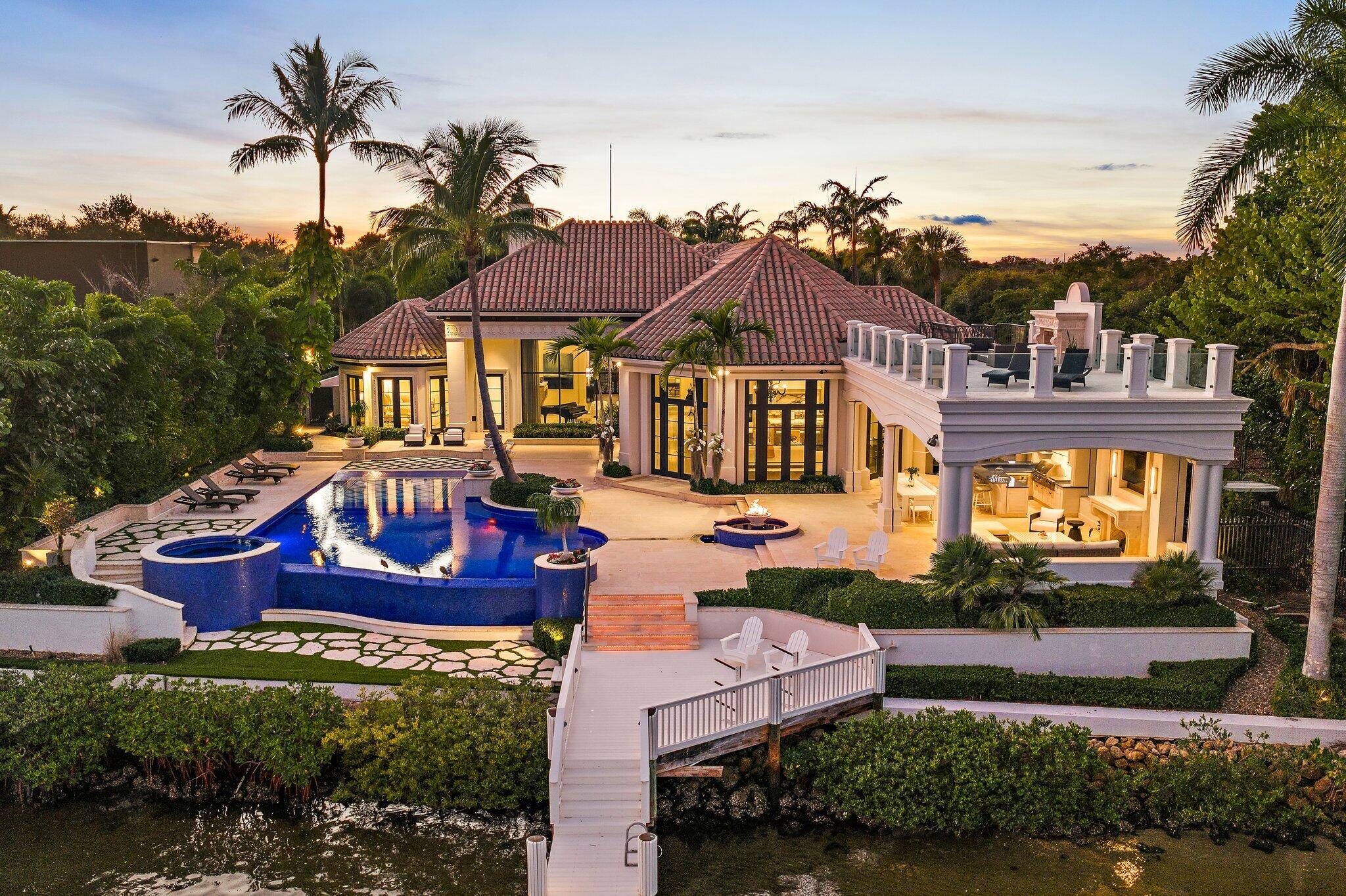 Located on one of the finest lots in Admiral's Cove, this signature, turn-key property enjoys endless views of nothing but water and nature with 115 feet of frontage, directly on the Intracoastal Waterway.  Rebuilt from the ground up in 2012, then renovated and repurposed by one of the top area builders in 2023, no expense was spared to restore the estate with next level finishes and the finest craftsmanship.  A few of the upgrades include:  painting the entire home inside and out, all new AC units, reimagined primary suite and den/office, converted 2nd floor salon and playroom into a VIP guest suite, added custom trim throughout, all hardwood floors refinished, new Control 4 home automation system, new Crestron lighting system, new home theatre equipment and TVs throughout new chandeliers and other light fixtures throughout, replaced the water heaters, added two sets of washers and dryers and replaced other appliances, rebuilt fountains, new pool equipment, resurfaced pool "penny" tiles, rebuilt summer kitchen, extensive landscaping replacement including new turf and activities side yard transformed into entertainment area, new outdoor lighting and LED replacement lighting inside, replaced gas lines and rebuilt outdoor gas lanterns, and added custom or curated furniture and window treatments throughout the home.  Admiral's Cove is one of the finest luxury club communities in the Palm Beaches with the best of everything - 24/7 manned, gated and roving security, championship golf, a private marina, tennis, swimming, fine dining, kids club, and much more.
