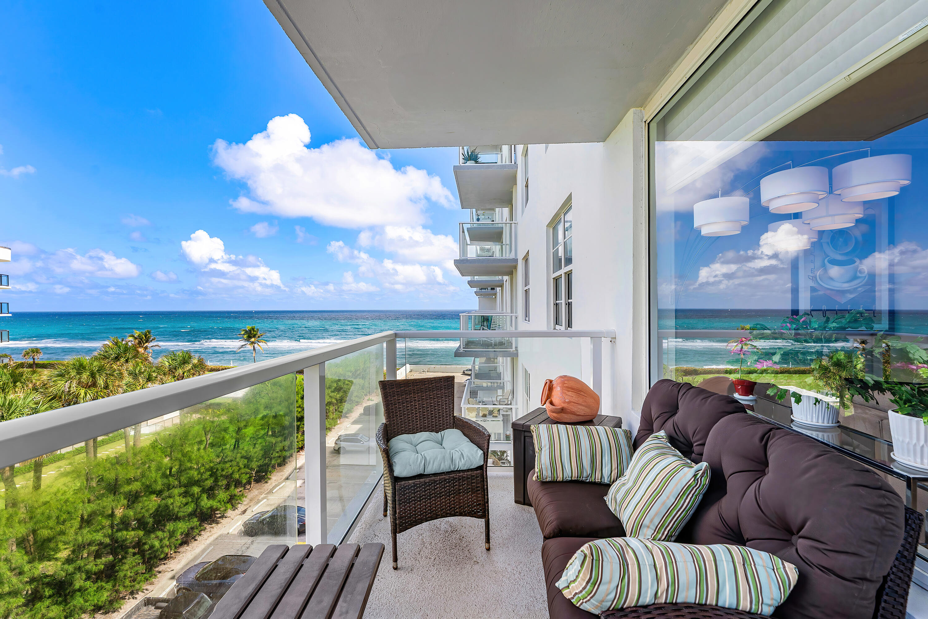 Located on the oceanside in South Palm Beach, this beautifully renovated 2-bedroom, 2-bath residence offers 1,548 square feet of living space--larger than most two-bedroom units in the building--and showcases sweeping views of both the Atlantic Ocean and the Intracoastal Waterway. Enjoy spectacular sunrises and sunsets from your private, covered balcony complete with modern glass railings to optimize the views. This open-concept split floor plan features spacious living and dining areas designed for effortless coastal living and entertaining, complemented by tile flooring throughout, Upgraded bathrooms, a  gourmet kitchen and a built-in bar. Impact windows provide abundant natural light along with added storm protection and are enchanced by Hunter Douglas custom blinds. The Patrician condominium has recently completed extensive building renovations and offers exceptional amenities including a resort-style oceanfront pool & pool deck with lounge areas & an outdoor kitchen with BBQ grills, private beach access, and a fitness center. Two covered parking spaces are included. The monthly COA includes fully funding reserves.