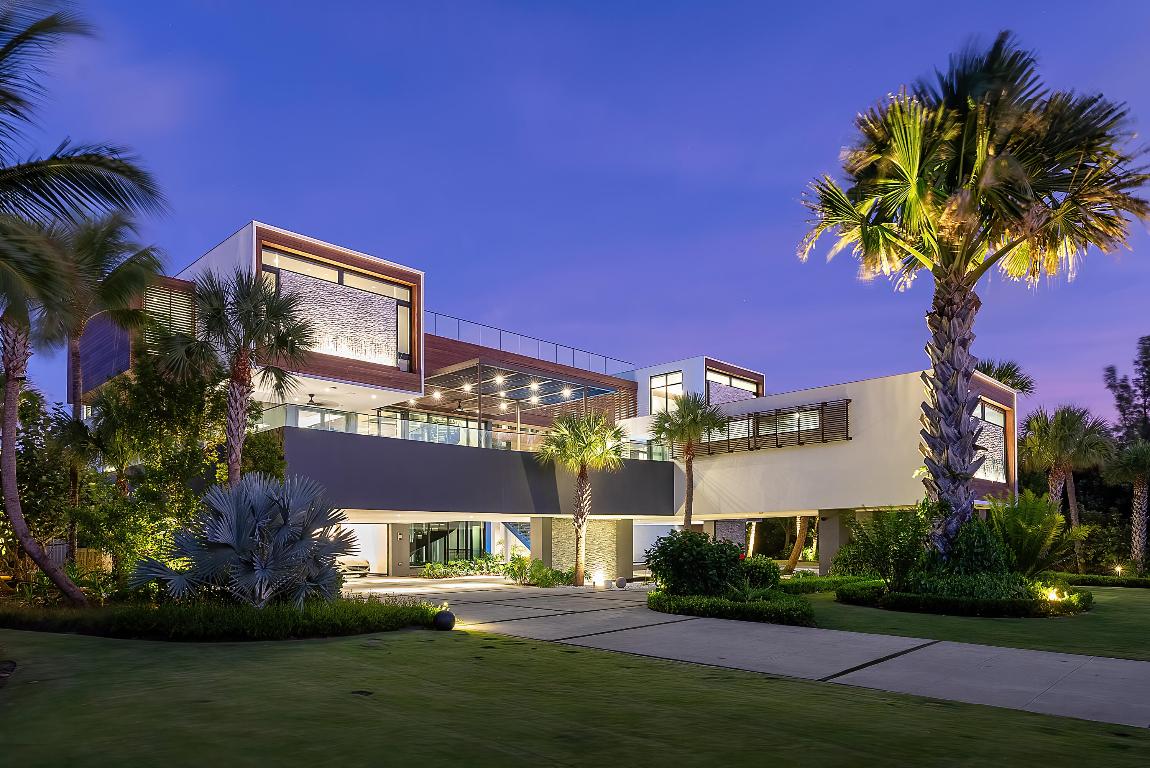 This extraordinary oceanfront property, located on sought after Hutchinson Island, offers a combination of modern design and practical luxury. Situated on a 2.3+ acre double lot in the gated neighborhood of Galleon Bay, it provides an impressive 239 feet of unobstructed oceanfront, making it a highly coveted and picturesque location. The home's contemporary design, completed in 2019, seamlessly blends aesthetics with functionality, and from the moment you step inside, a two-story glass wall on the second floor offers breathtaking views of the Atlantic Ocean. Not only does this house exude modern luxury, it provides unparalleled security and privacy. The open-concept kitchen, with an oversized island, is ideal for cooking and entertaining, and it flows into the main dining and living spaces, creating a seamless connection between the interior and the captivating outdoor environment. Two additional rooms offer flexibility for use as offices or bedrooms, adapting to your needs. The property features both river and ocean pools with a heated spa, providing options for relaxation and recreation.

On the third level, the main suite is a luxurious retreat, equipped with a morning bar, fireplace, living wall, an infinity tub, glass shower, and expansive boutique closets. There are two more guest rooms with water views and en-suite baths, ensuring awe inspiring views from all over the house. The ground level offers an array of amenities, including two separate garages, a fitness center, theater, game room, lounge, outdoor shower, basketball court, and waterscapes. All throughout the grounds you will find custom water features, impressive mature landscaping and even a basketball court hidden on the massive property. 

For added convenience, the property is equipped with a complete home generator and Creston home integration. This stunning oceanfront estate is a harmonious blend of modern luxury and practicality, offering a comfortable and opulent lifestyle in a truly picturesque and private setting on the Treasure Coast of Florida.