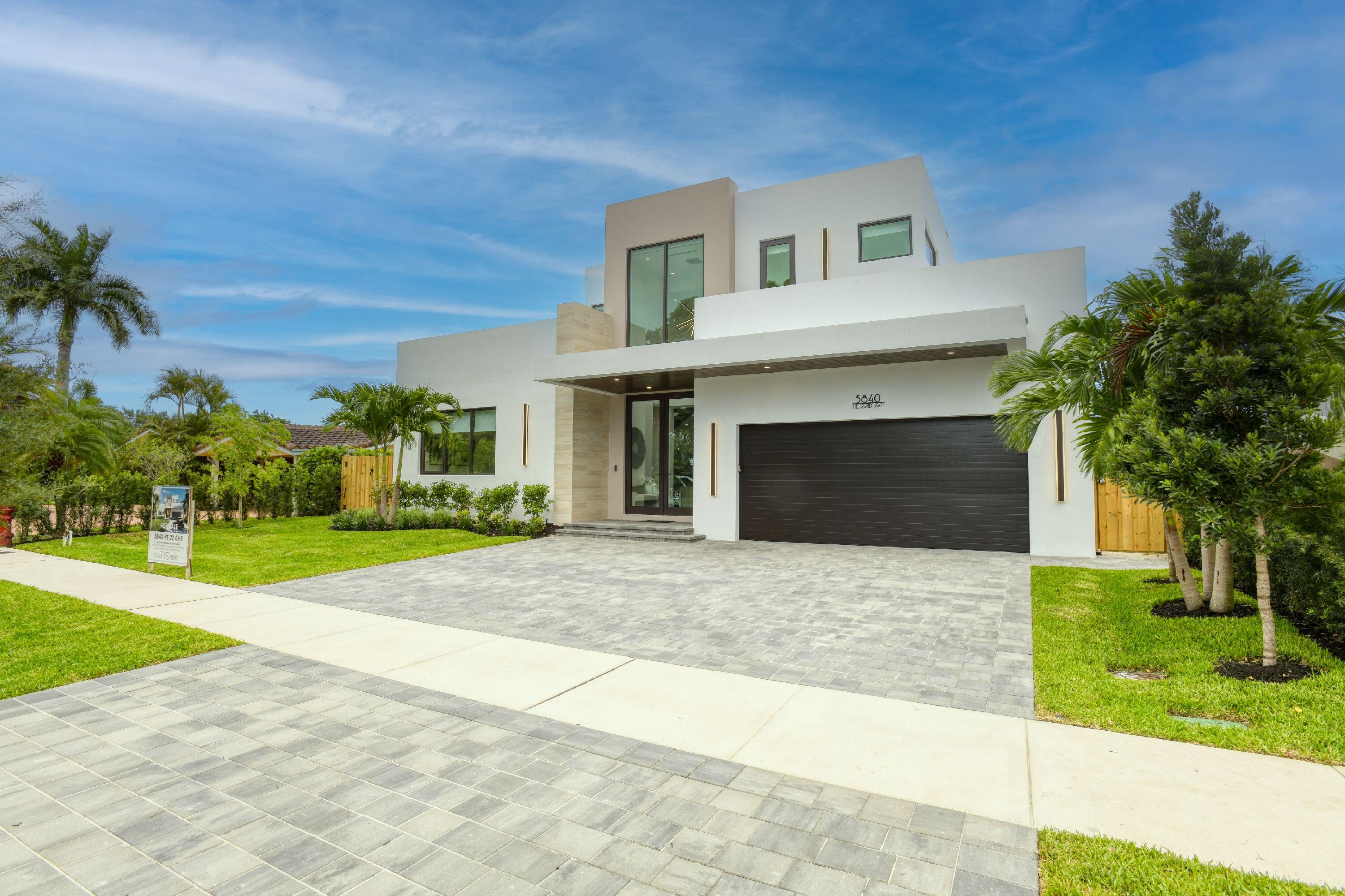 Brand new 2026 construction in Imperial Point. Meticulously engineered modern home with floating LED marble staircase commanding 10-foot ceilings (11-foot in primary). First-floor primary suite: solid core doors, oversized custom closet with dedicated washer/dryer, freestanding tub, direct pool access. Gourmet kitchen: 6-burner JennAir cooktop, dual smart ovens, 10'-8" island with waterfall edges. Resort-style saltwater pool w/ Jandy equipment, travertine decking, built-in Paradise Grills outdoor kitchen. Heated saltwater pool 5 ft deep. 4 additional en-suite bedrooms, upstairs & downstairs laundry rooms. Smart home: Generac generator, tankless water heaters, dual-zone HVAC, 4K cameras, Sonos system, motorized shades on all windows. All closets & bath accessories installed. Move-in ready!