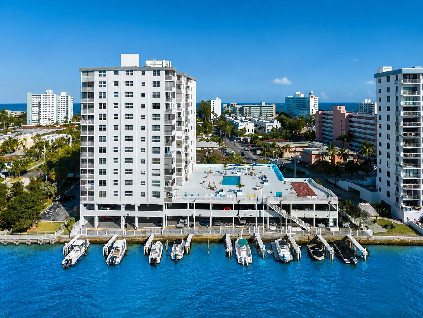 ATTENTION ONE BLOCK DISTANCE TO BEAUTIFUL LIGHTHOUSE POINT BEACH, AND DIRECTLY ON THE INTRACOASTAL WATERWAY WITH STUNNING SALT WATER VIEWS AND A CONTINUOUS BOAT PARADE. Gorgeous 2 bedroom/2bathroom condo, completely renovated. The unit has a large beautiful deck with ocean and Intracoastal views with the Lighthouse. The kitchen has new stainless-steel appliances, quartz countertops, recessed lighting, upscale cabinets, and a garbage disposal. The master bedroom has a large walk-in closet. The bathrooms are completely remodeled with granite tops, gold fixtures, through out with beautiful tiles. The unit comes with an assigned parking space in a covered garage that leads to the 12 docks, 30' limit, rented when available. We have the water taxi at a beautiful park next to the building. Currently under construction, SOME PICTURES ARE AI STAGED...decks a few months from completion, new roof finished. Third floor has the pool and is also under construction which will be a bit longer. Tiki bar also on the pool deck which overlooks in stunning fashion the Intracoastal and ocean.