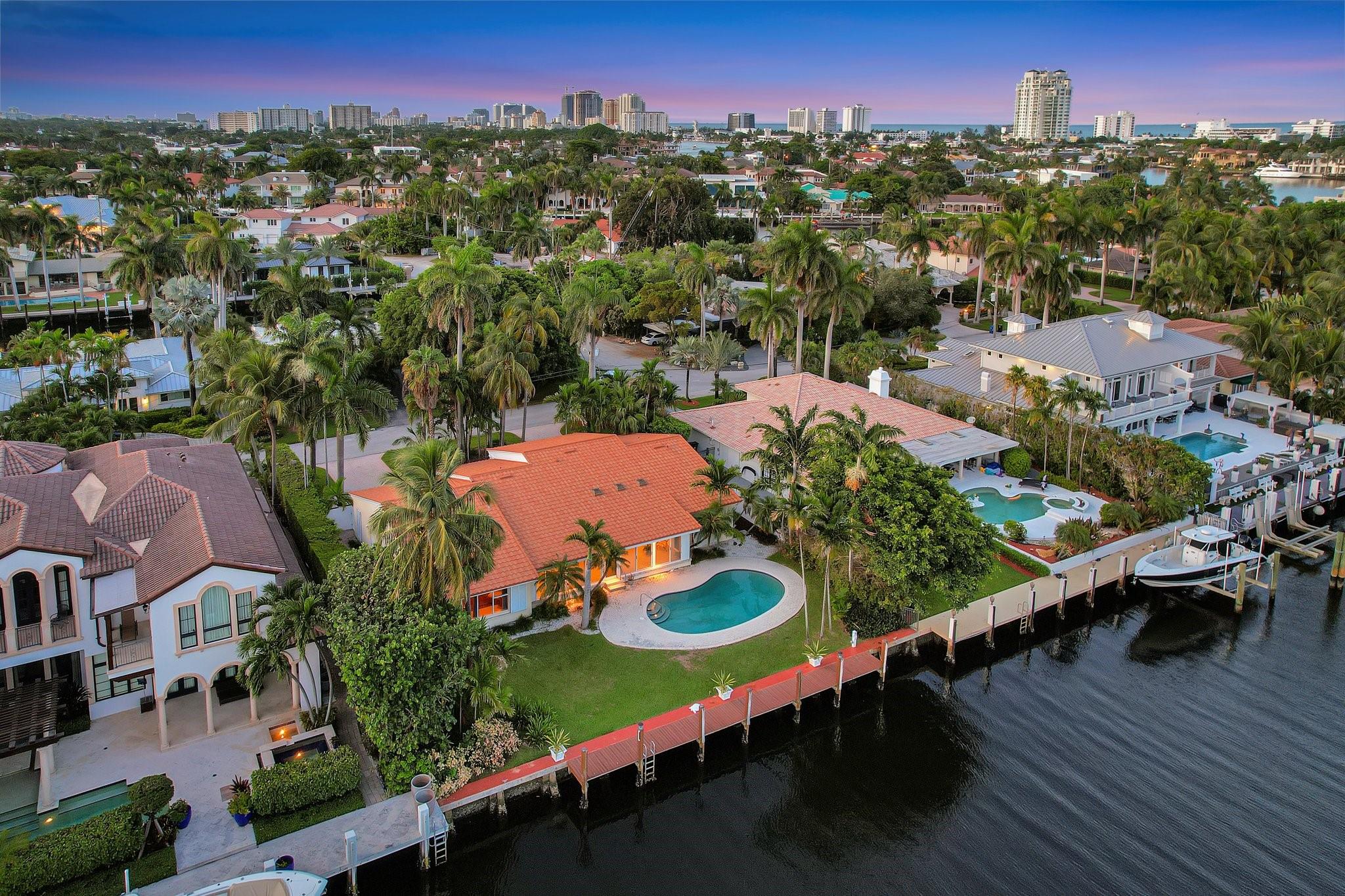 One of only 250 deepwater residences in coveted guard-house gated Harbor Beach offering deeded surf club & private marina! This superior property is located on one of the widest & deepest 150ft canals. The rare & highly desirable waterway is perfect for wider yachts/catamarans (95 ft dockage) & also affords more privacy to the pool area. Lucille Drive is privately located off the main thoroughfare. Do not overlook the potential of this light & bright charming SoFlo bungalow - cuban floors, vaulted ceilings, large flowing living/entertaining area & functional floorplan. Seeking to build? This prime property 95 x125 ft deep, approaching 12,000 sf with the potential to build 3 levels & approx 10,000 sf total. Police surveillance & easy proximity to SE 17th St, Port, shopping, dining & airport - Architectural renderings by Architect Bruce Celenski