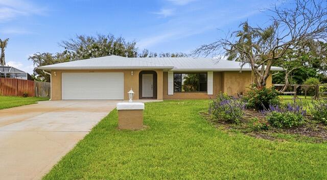 Welcome to this inviting pool home situated on a beautiful fenced & oversize lot.  Offering 3 generous bedrooms and 2 bathrooms (one serving as a cabana bath for the pool and patio), this home is ideal for families, entertainers or anyone seeking indoor-outdoor Florida-style living.  Step inside to discover an open layout with comfortable living spaces for everyday living.  This is a split bedroom plan, offering privacy.  The oversized fenced yard provides room to play, garden or simply relax in your own tropical oasis.  Granite in kitchen & bathrooms; Metal roof 2023; main AC 2019; 2nd AC 2022; water heater 2025; full panel storm shutters; new gutters 2026; pool deck painted 2026; Come see this wonderful home for yourself today!