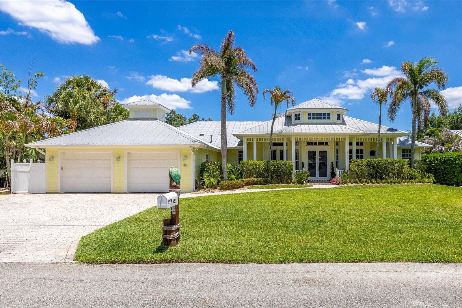 Beautiful custom-built waterfront home with private pool on wide canal with 100' water frontage, ocean access, deep water,50' dock, two boat lifts, (20K, 8K) and kayak floating dock. The open kitchen boasts marble countertops, island, custom cabinetry, adjoining dining space and sitting area with fireplace. Two story ceiling in formal living room with formal dining space and sliding doors opening to lanai. Primary bedroom offers access to lanai, dual-sink vanities, walk-in shower, water closet and corner tub. The additional en suite room can be used as an office, family room or 4th bedroom. Outdoor living is spacious with enclosed lanai, heated saltwater pool and spa, summer kitchen and Tiki hut. Bright spacious home with great water views.