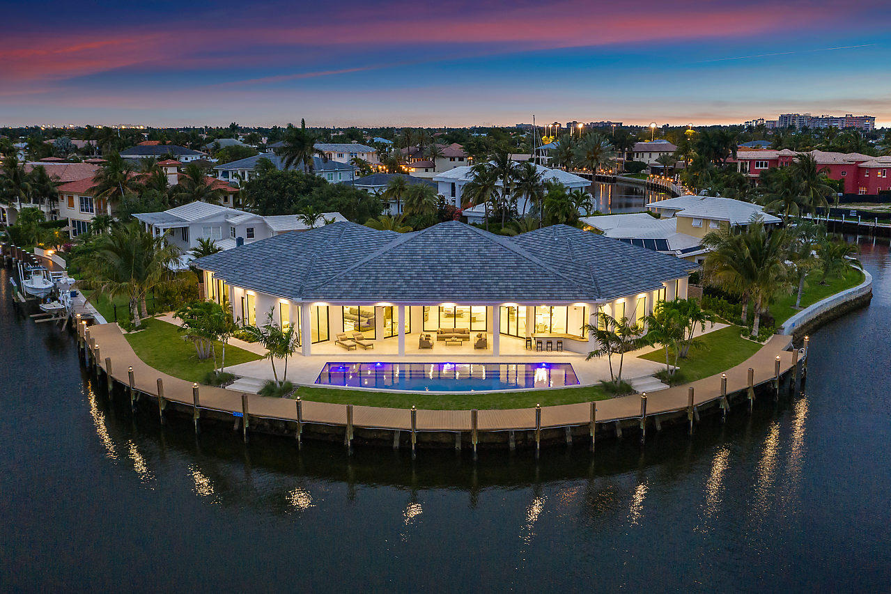 Stunning New Construction contemporary modern home  located on a over-sized point lot with 243 of of deep water  & minutes to the Hillsboro Inlet.   Features include:   Incredible views from every room, custom wood flooring,  high impact hurricane glass,  Wolf and subzero appliances, smart home technology throughout, Toto toilets, open theater room and wet bar, natural gas generator, large lap pool, huge covered Summer Kitchen with grill, and so much more.
