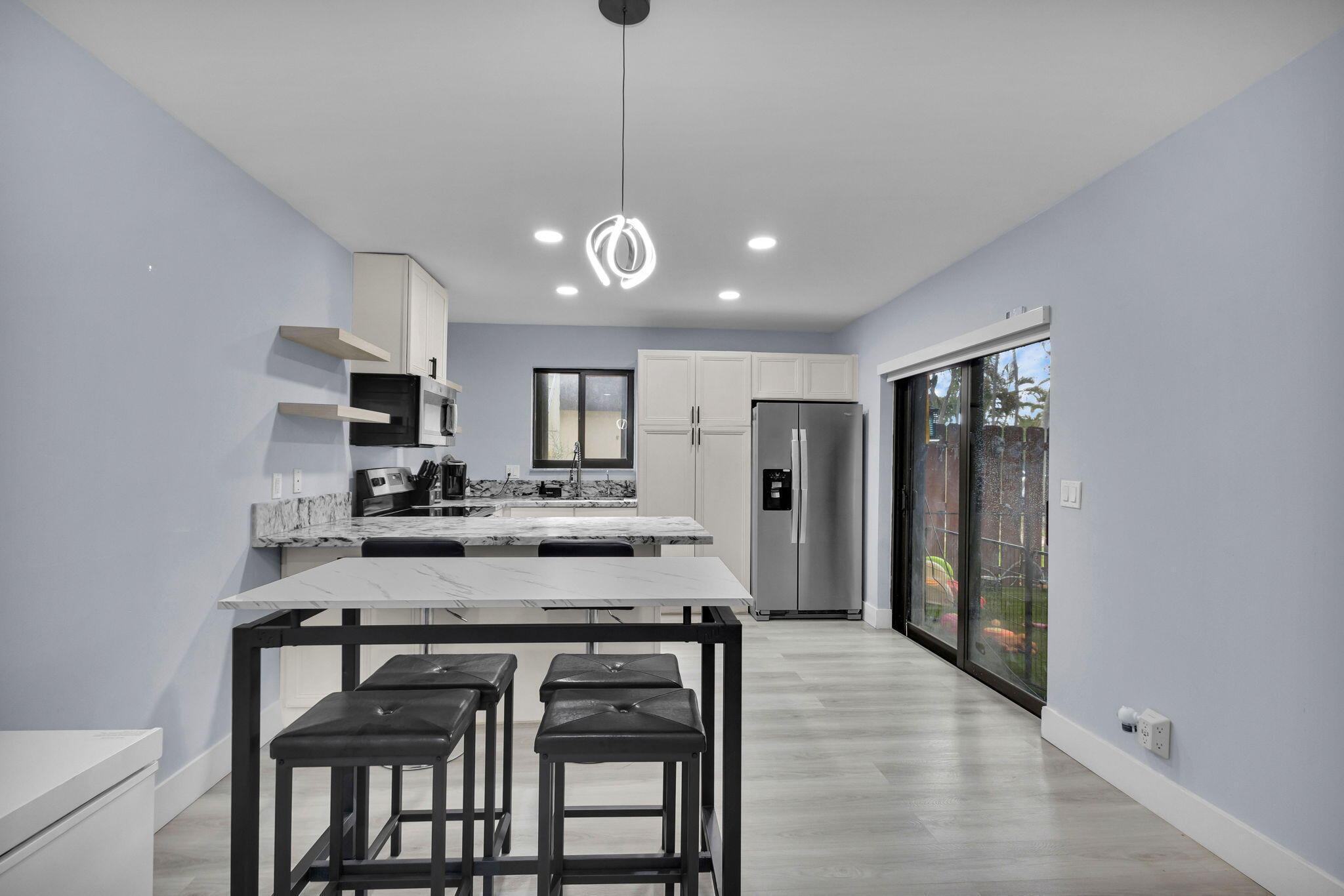 Welcome to this beautifully remodeled 2 bedroom, 1.5 bathroom townhome in Kirkwood Village! This townhome has $20K+ in features and upgrades! This light and bright townhome has a fully remodeled, modern kitchen with granite countertops, stainless steel appliances, ample storage and reverse osmosis water filtration system. New vinyl flooring throughout, new high hat lighting, tankless water heater, full size washer dryer, accordion shutters, storage shed in your terrace, avocado tree and new roof in 2023. The community pool and tennis courts are steps away from your terrace. Less than 20 minute drive to PBIA, CityPlace, Palm Beach Zoo and beautiful beaches!