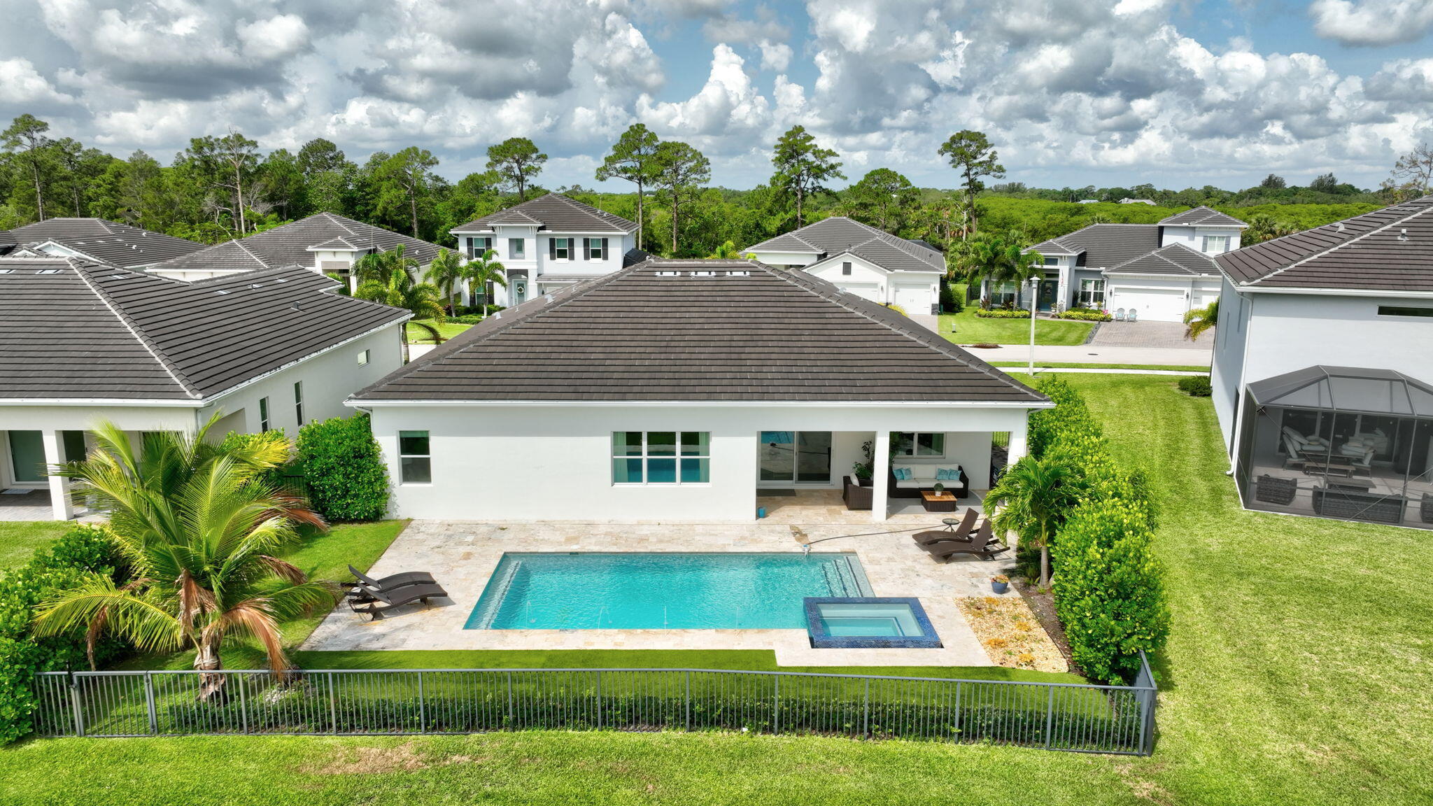 Welcome to your dream home in the highly desirable Banyan Bay community! This beautifully designed one-story residence offers 3 spacious bedrooms and 2.5 bathrooms, blending modern comfort with timeless style. Abundant natural light fills the home through impact windows, creating a bright, open, and inviting living space. The chef-inspired kitchen is the heart of the home, featuring elegant granite countertops, stainless steel appliances, rich wood cabinetry, and a generous pantry, perfect for both everyday living and entertaining. Step outside to your own private backyard oasis, complete with a **sparkling private pool and relaxing spa** the perfect setting for enjoying Florida's year-round sunshine, entertaining family and friends, or unwinding after a long day. Escape to the expansive  primary suite, your own private retreat, complete with a spa-inspired bathroom and an oversized walk-in closet designed to meet all your storage needs. Please note that the furnishings shown in the photos were used for staging purposes only. As a resident of Banyan Bay, you'll enjoy exceptional community amenities, including a beautifully appointed clubhouse, resort-style swimming pool, and fully equipped fitness center. Ideally located with convenient access to I-95, shopping, dining, parks, and top local attractions, this home offers the perfect combination of comfort, convenience, and Florida living at its best.