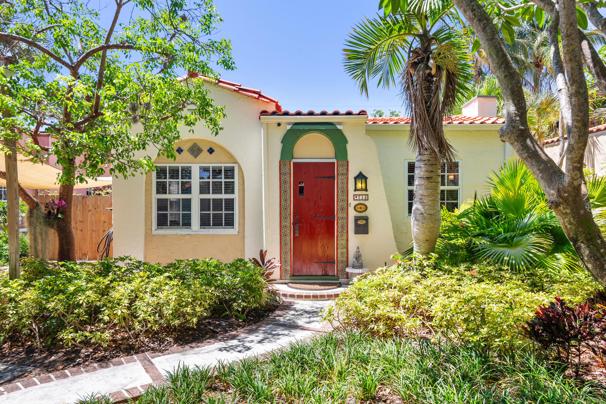 This historic Flamingo Park home was designed by noted architect Hansell Hall. Featuring his signature details, hollow tile construction, barrel tile roofs, mitered hardwood floors, cast stone fireplace, breakfast nook, sunporch, high ceilings, arches, arches & more arches. This 2BR+Den/2BTH home with beautiful guest cottage is situated on a premier tree canopied street on the "Hill Block" of this highly sought-after downtown neighborhood. Beautifully & carefully restored to preserve and showcase the original details of this 1928 gem. Pecky cypress front door, iron light fixtures, French Doors, large light filled rooms all protected by hurricane windows. Large primary suite with walk-in closet, new roof in 2026, solar panels, updated electric & plumbing. Lush mature tropical landscaping.