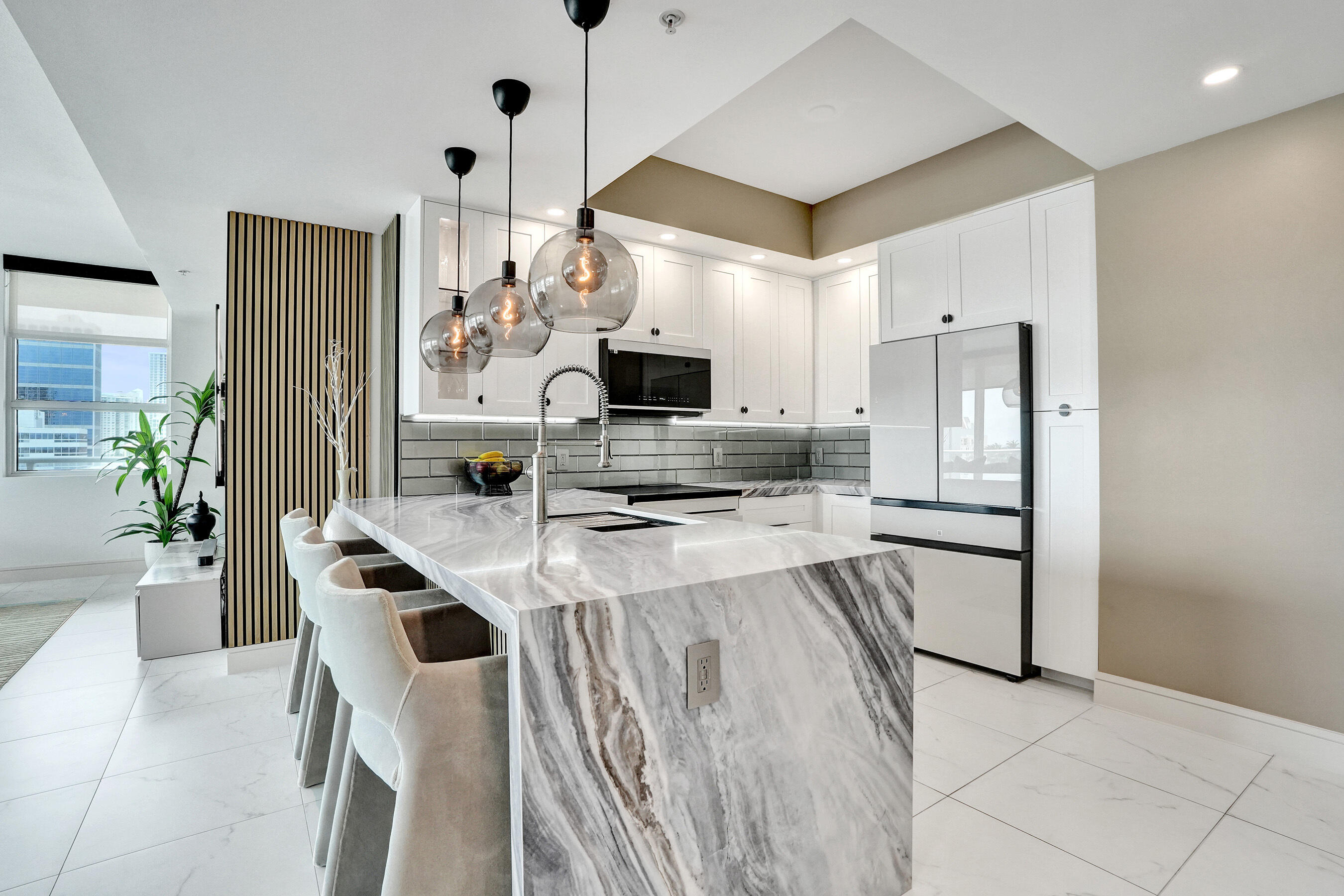 WOW!!!..Absolutely GORGEOUS with SWEEPING SKYLINE VIEWS from your wrap around balcony...in a prime downtown location! The ultimate urban lifestyle with restaurants, vibrant nightlife, and cultural attractions just moments from your doorstep! This exceptional residence has been meticulously and completely renovated from the stunning porcelain floors to the CUSTOM LIGHTING in every room (wifi operated GoogleHome System). New kitchen with stunning waterfall countertop and backsplash, Custom bar area with wine cooler, ALL NEW APPLIANCES, built in lighted closets, AUTOMATIC BLINDS in EVERY ROOM. New BATHROOMS and POWDER ROOM with Designer Wallpaper. Washer/Dryer, NEW A/C and modern A/C vents, All new doors, hardware, and baseboards. Two parking spaces. 24 hr security. A truly stunning home!
