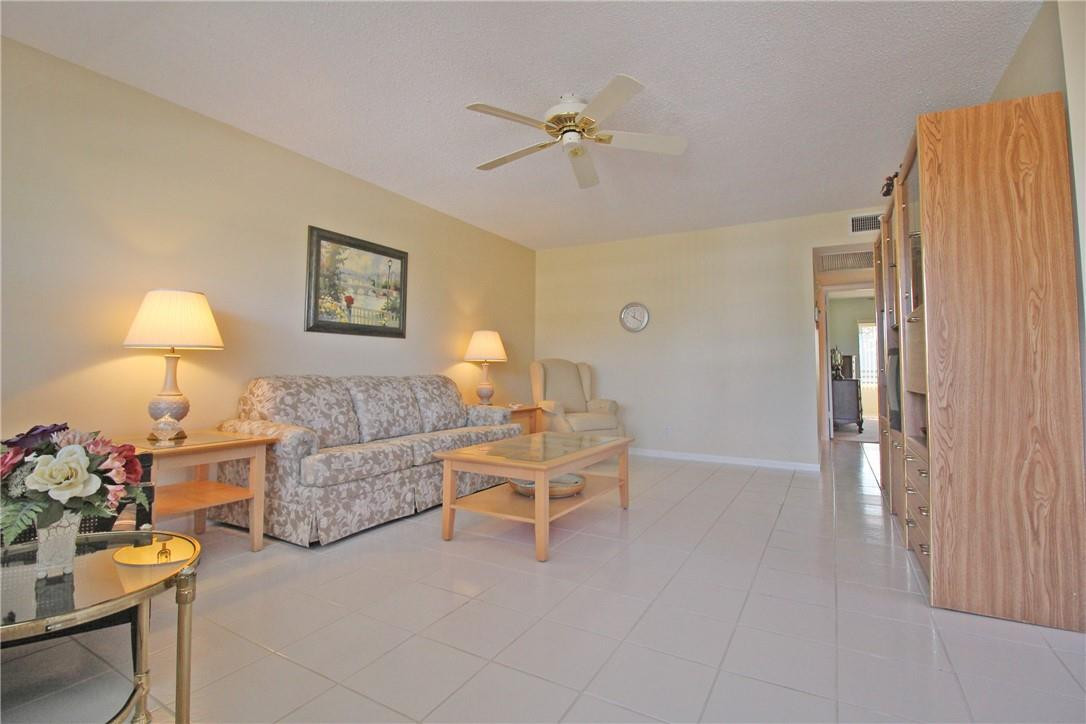 LIGHT FILLED CORNER CONDO!! YOU WILL LOVE THIS 2 BEDROOM 1.5 BATH ON THE 2ND FLOOR! IT IS BRIGHT, AIRY AND JUST STEPS TO THE POOL!! THIS UPDATED KITCHEN FEATURES AN EXTRA CABINET, DOUBLE SINK AND FORMICA COUNTER TOPS! FULLY FURNISHED AND READY FOR GUESTS WITH A SOFA BED IN THE LIVING ROOM AND GUEST ROOM! PRIMARY BEDROOM HAS BATHROOM CONNECTED INSIDE THE ROOM! UPDATED WITH TILED SHOWER STALL! BOTH BEDROOMS HAVE SLIDING GLASS DOORS TO THE PATIO!! NON- RENTAL & FINANCIALLY STABLE BUILDING! ! CENTURY VILLAGE EAST IS A GATED COMMUNITY WITH 24 HR SECURITY & FREE BUS SERVICE! JUST 3.5 MILES FROM GORGEOUS DEERFIELD BEACH! ENJOY THE 5 STAR CLUBHOUSE WITH CLUBS & CLASSES GALORE, FITNESS CENTER, 15 POOLS, TENNIS, PICKLEBALL DANCING, & SO MUCH MORE!!!MAKE THIS YOUR WINTER HOME!! ASSOC. CLAIMS 55+
