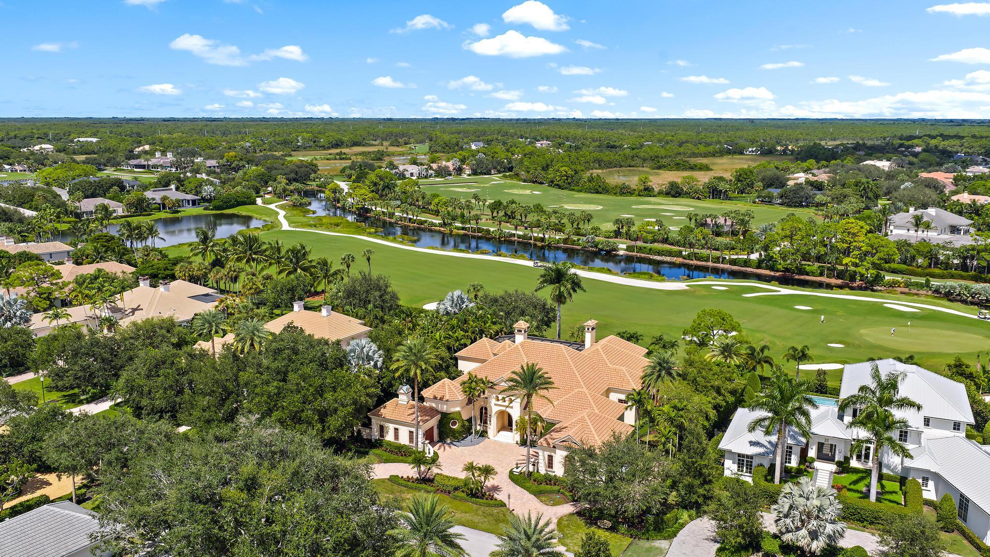Exquisite custom estate with breathtaking views of the first hole of the Pete Dye Championship golf course.  Old Marsh Golf Club is one of the finest gated club communities in all of Palm Beach County with a limited membership to only 275 members, a no tee time policy and a renowned caddie program. Old Marsh is a gated enclave of 180 custom estates and easy access to Palm Beach International Airport and is located only minutes to 5-Star dining, beautiful beaches and renowned Palm Beach shopping. The residence boasts the finest quality throughout with custom craftsmanship, imported finishes and no detail overlooked.  Designed by Village Architects and built by First Florida Construction, this estate features dual baths in the primary bedroom, custom theater room, a spacious office and two beautiful ensuite guest suites.  The details are truly endless with onyx, wormy chestnut ceiling detail, steam shower, custom kitchen, sliders from the family room opening to an expansive outdoor loggia space with fireplace and elaborate summer kitchen overlooking a separate outdoor fire pit with marble pavers and turf inlay, a beautiful Royal Palm and a specimen Canary Island Palm.  Adjacent is an expansive, reinforced concrete and screen pool enclosure surrounding a large swimming pool and spa area with a shear decent waterfall, bronze bird fountain and lush landscaping.  Too many details to include - this property has been extremely well thought out, designed and constructed for the finest lifestyle, exceeding even the highest expectations of the most discerning clientele.