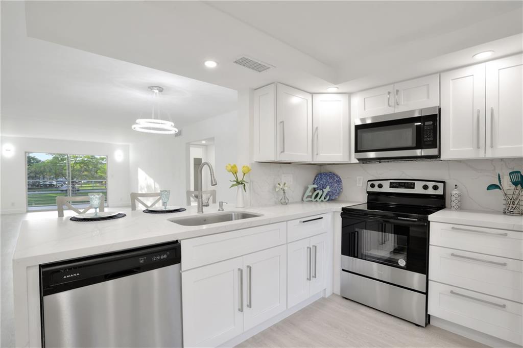 DESIRABLE DELUXE MODEL 2BEDROOM/BATH WITH W/D INSIDE THE CONDO. PRIME LOCATION!. BEAUTIFUL AND FULLY RENOVATED WITH BRAND NEW WHITE KITCHEN CABINETS + WHITE CARRARA QUARTZ COUNTERTOPS. TOP OF THE LINE STAINLESS STEEL APPLIANCES. OPEN KITCHEN CONCEPT. WATERPROOF VINYL FLOORS THROUGH-OUT. RENOVATED BATHROOMS WITH NEW VANITIES + NEW TOILETS+ MIRRORS + DESIGNED SHOWERS. GLASS SHOWER DOORS. PORCELAIIN FLOORS IN LANAI. COME AND ENJOY THE GORGEOUS VIEW OF THE LAKE AND FOUNTAIN FROM BALCONY. A MUST SEE!. ASSOC REQUIRES 20% DOWN & 1 OCCUP 55+ VACANT/CLICK ON SHOWING ASSIST