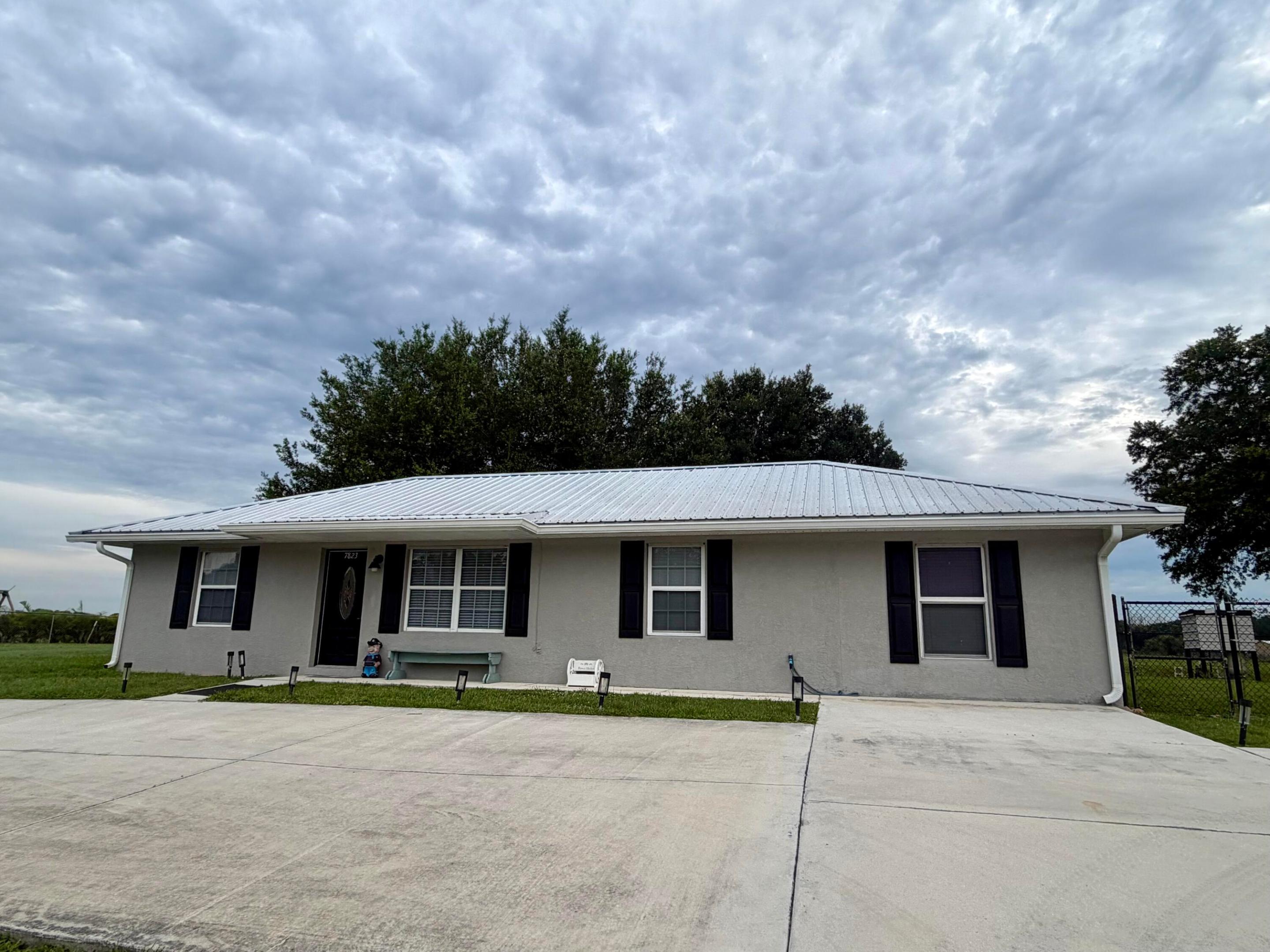 Welcome to this charming 3-bedroom, 2-bathroom single-story residence nestled in the desirable Sunrise Estates Subdivision in Okeechobee. This thoughtfully designed home offers 1,296 square feet of comfortable living space and 2272' under roof. The property has been immaculately maintained.. The single-car garage provides convenient storage and shelter with electricity, air conditioning, and water, while the waterfront location offers a unique opportunity to enjoy the natural beauty that defines this area. The  home has a new metal roof (2023), new air conditioner, new hotmail heater (2026), new refrigerator, newly remodeled bathroom- with handicap features-, insulated screen room , new paint inside and out . This home is move-in-ready!