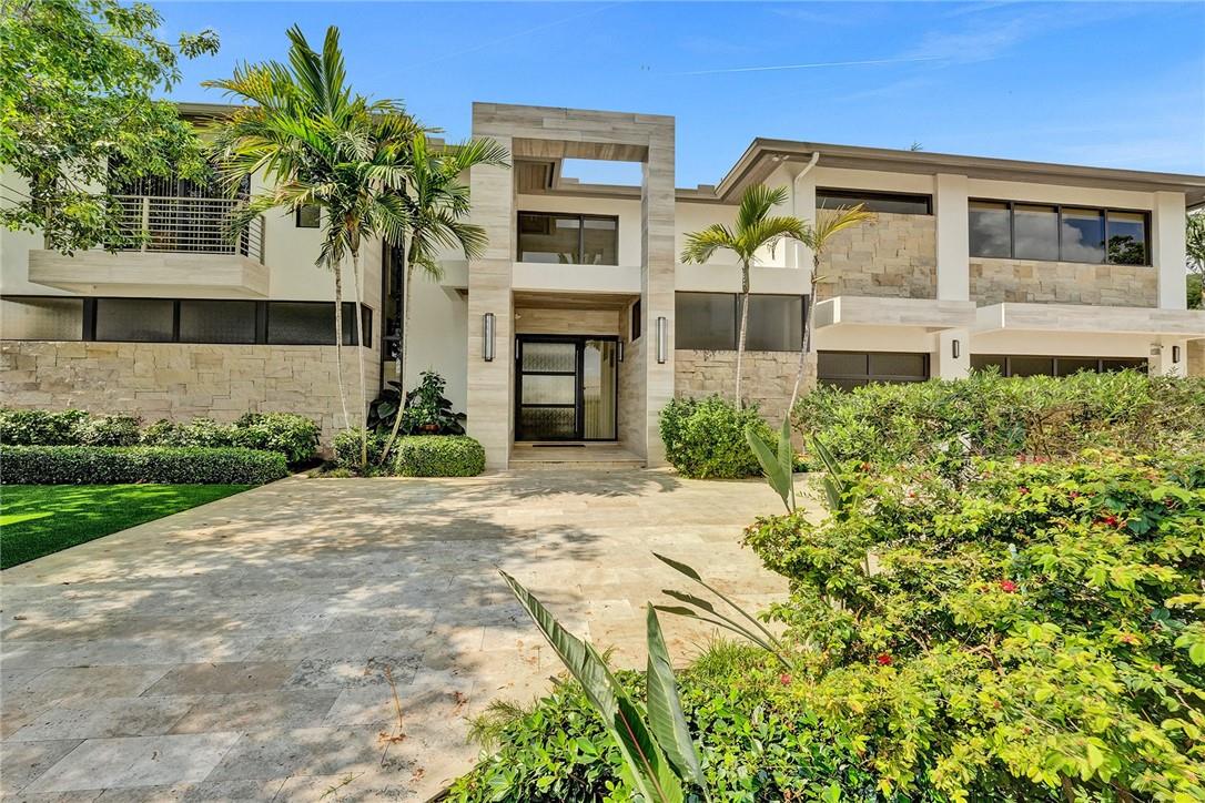 Indulge in Luxury Living at this Exquisite Waterfront Coral Ridge Gem! Built in 2018, this Opulent Contemporary home has 5-bedrooms, 5-baths (+2 half baths). 5,427 sq ft of living area (6,109 total area) offers Tranquil Resort-Style living. 21-ft high ceilings in the living area plus the Gallery Bridge create a sense of openness and extravagance. Folding Sliding Glass Doors create a Harmonious Connection to the Outdoor Kitchen, Heated Pool and Spa. Chef's Kitchen features Double Islands, Butler's Pantry, Duel Dishwashers, Premium Appliances and Refrigeration. Extensive Balcony overlooking Pool and Waterway. Additional features include Elevator, 2 Primary Suites, 2 Laundry Rooms, Office, 3-car garage, Entire Home Generator and Natural Gas. New Seawall and Dock ensure durability. Indulge in the epitome of luxury living with this exquisite waterfront gem nestled in Fort Lauderdale's prestigious Coral Ridge neighborhood. This opulent 5-bedroom, 5-bathroom (plus 2 half bathrooms) home spans 5,427 sq ft of living space (6,109 total sq ft) and boasts unrivaled amenities that redefine the concept of resort-style living.Situated on a canal with no fixed bridges, offering seamless ocean access, this property provides a picturesque setting with 70 feet of waterfront splendor. A new seawall ensures both durability and peace of mind, while the contemporary design and all impact glass showcase the perfect blend of style and functionality.Step inside to discover the grandeur of 22 ft high ceilings in the living area, creating a sense of openness and extravagance. The presence of an elevator adds convenience and accessibility, allowing you to effortlessly navigate between floors. A captivating gallery bridge on the second floor adds a touch of architectural elegance, further enhancing the luxurious ambiance.Prepare culinary masterpieces in the chef's kitchen, which features not just one, but two kitchen islands, providing ample space for both food preparation and entertainment. The presence of natural gas appliances elevates your cooking experience to new heights, while the thoughtfully designed layout ensures that every aspect of the kitchen meets the highest standards of functionality and style.In addition to the exceptional kitchen, this home offers an array of lavish amenities that cater to your every desire. With two laundry rooms, daily chores become a breeze. The 3-car garage, adorned with sleek glass doors, adds a touch of sophistication and convenience.Immerse yourself in the seamless blend of indoor and outdoor living as the folding sliding glass doors create a harmonious connection to the outdoor oasis. Relax and rejuvenate in the heated pool and spa, while a whole home generator ensures uninterrupted comfort and peace of mind.Experience the allure of the Coral Ridge neighborhood, where world-class shopping centers, parks, and entertainment venues are just moments away. Embrace the resort-inspired lifestyle and discover the true meaning of opulence in this remarkable home.