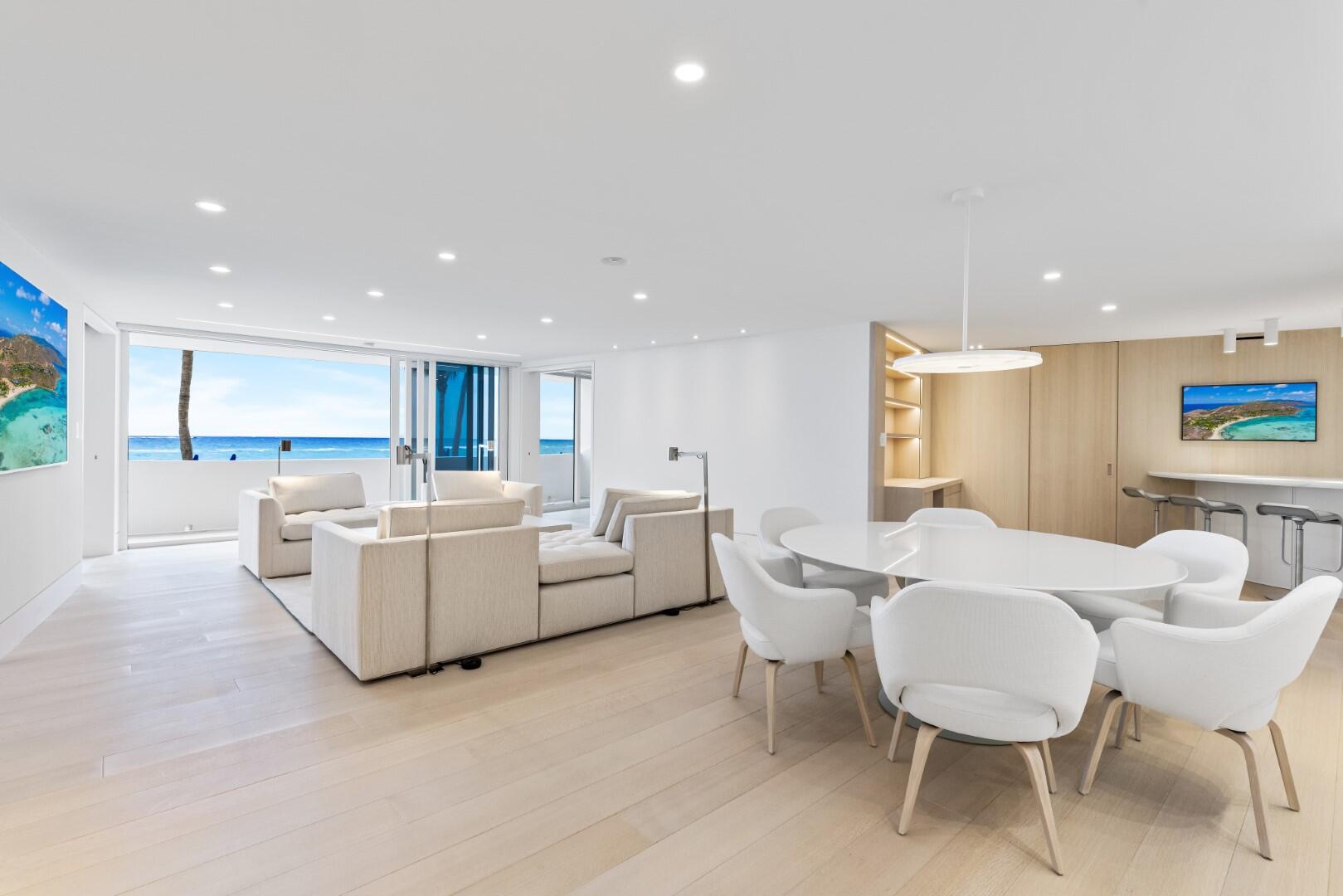 Gorgeously remodeled 2BR/2.1BA Oceanfront Condominium in the sought-after Sun and Surf. Stunning oak wood flooring and impact glass throughout. Great room features beautiful ocean views, motorized blackout and sunshades, and hidden art hanging tracks. Beautiful kitchen with marble countertops and backsplash, and Subzero, Miele, and Wolf appliances. Custom cabinetry, breakfast bar, and office with convertible desk. Waterfront Owner's Suite with custom riffed oak paneling, custom desk, and extra storage in king-size bedframe. Guest Suite features king-size Murphy bed, ocean views, and custom vanity and shower. Additional highlights include hidden door accessed laundry area with custom cabinetry, hidden door accessed wet bar and storage, pocket door accessed custom bookshelf, and stunning marble-walled powder room. The Sun and Surf is a fabulous, full service building with valet, swimming pool, exercise room, full time management, and beach access.