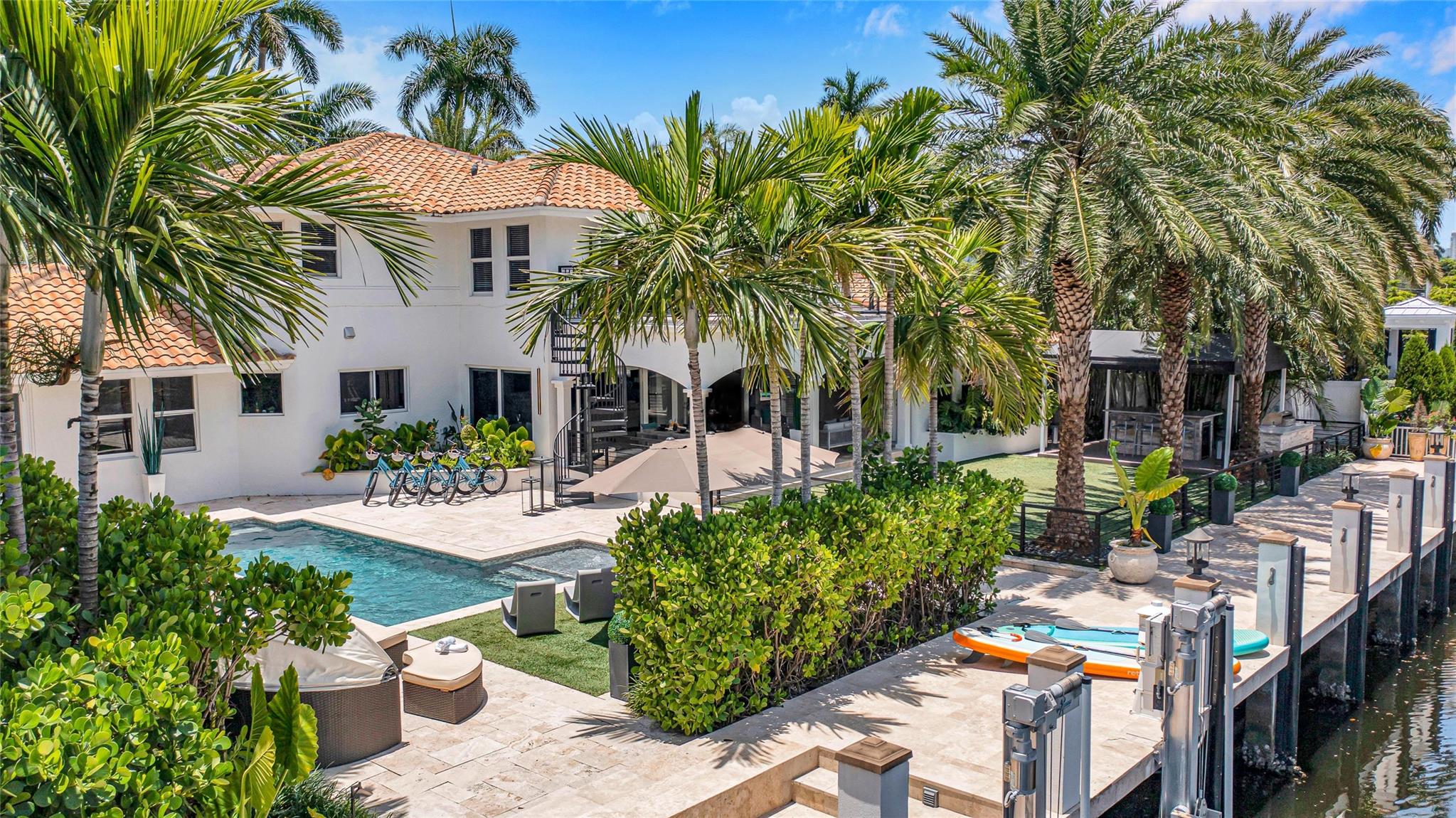 This prestigious home is in the guarded community of Seven Isles. A renovated & stunning waterfront estate with a rare 100' of waterfront off Las Olas Blvd & Ft. Lauderdale Beach. On 1/3-acre, the lush landscaping creates the feel of a private oasis. Inside 4 of 6 bedrooms are suites & a full bath dedicated as a cabana bath. The primary suite has water views & a private balcony. Additional features outside: heated pool, summer kitchen, large turf space & covered lanai. Windows are wind-rated & full home natural gas generator. Dock up to an 80ft yacht, 12k-lb boat lift, direct ocean access no fixed bridges! East-West canals mean a constant sea breeze & wide waterways. The North rear exposure = privacy from high-rise condos creating an unparalleled estate. Currently a cash flowing luxury STR Elegantly renovated and nestled in the prestigious, gated enclave of Seven Isles; 2323 Delmar is just off the world famous Las Olas Blvd and Ft. Lauderdale Beach! This stunning waterfront estate offers the perfect blend of luxury, comfort, and unparalleled location. Rare 100’ of prime waterfront, the property boasts breathtaking water views and an expansive open-concept layout ideal for entertaining. Situated on a 1/3-acre private oasis, this transitional estate home is a true masterpiece of modern design and functionality.The bright and airy floor plan features a gourmet kitchen with double ovens, an island with cooktop and hood, and ample cabinetry, creating the perfect space for culinary enthusiasts. The adjoining game room and large living areas offer a seamless flow, opening onto the expansive patio where you can enjoy serene waterfront views. The gorgeous backyard is designed for the ultimate South Florida lifestyle, featuring a tropical pool, outdoor summer kitchen, and a covered lanai — all surrounded by lush landscaping for privacy.The luxurious primary suite is a true retreat, complete with picturesque water views and a spacious sitting area upstairs on the balcony. The serene ambiance continues throughout the home, with additional bedrooms each offering privacy and comfort.This exceptional property is also a unique investment opportunity as a turnkey luxury rental, providing lucrative cash flow potential. The property includes a newly installed 100-foot concrete dock with a 12,000-pound lift and a well-maintained seawall, offering direct ocean access with no fixed bridges. Wind-rated windows, a whole-house generator, and meticulous attention to detail, this residence offers peace of mind and effortless luxury.Just steps from Fort Lauderdale Beach, downtown, and Las Olas Boulevard, this home is ideally located for those seeking the best of both worlds — private, luxurious living with easy access to world-class dining, shopping, and entertainment.This property truly must be seen to fully appreciate! Tour this exceptional waterfront estate today and be blown away by its elegance, beauty, and unique features! Seven Isle is known and highly sought after for its canals that run east to west which allows for a constant sea breeze, each Isle is an island allowing for constant flow of water through the canals, wider canals, and having natural gas at each residence extremely rare for Fort Lauderdale! This property has a North rear exposure giving the backyard the most privacy from the high rise condos off of Las Olas Blvd. For these reasons mentioned and many others you will apricate owning this particular property over others in the area!