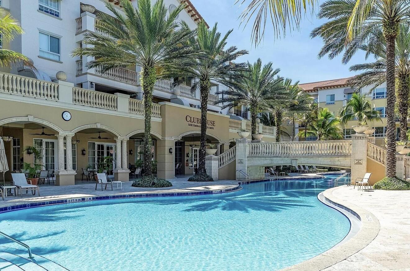 Welcome to this first-floor corner residence in the main bldg of the guard-gated 55+ community of The Palms Weston. Featuring 13+ High Ceilings with prime location near all activities/ amenities, this 2-bed, 2.5-bath condo has garden views and Large Balcony with a convenient private Patio Entrance that offers direct access to the grass area for easy pet walking. The kitchen has wood cabinetry & stainless-steel appliances. The open layout includes crown molding, laminate/tile floors throughout, 6-Yr Warranty on All Appliances + AC, Independent Storage Unit and 3-Main Entrance Ways. Primary suite offers a walk-in closet, dual vanities, and separate shower. Enjoy resort-style amenities & the convenience of an on-site Cleveland Clinic, plus proximity to Hospital, major hwys, Publix, & dining.