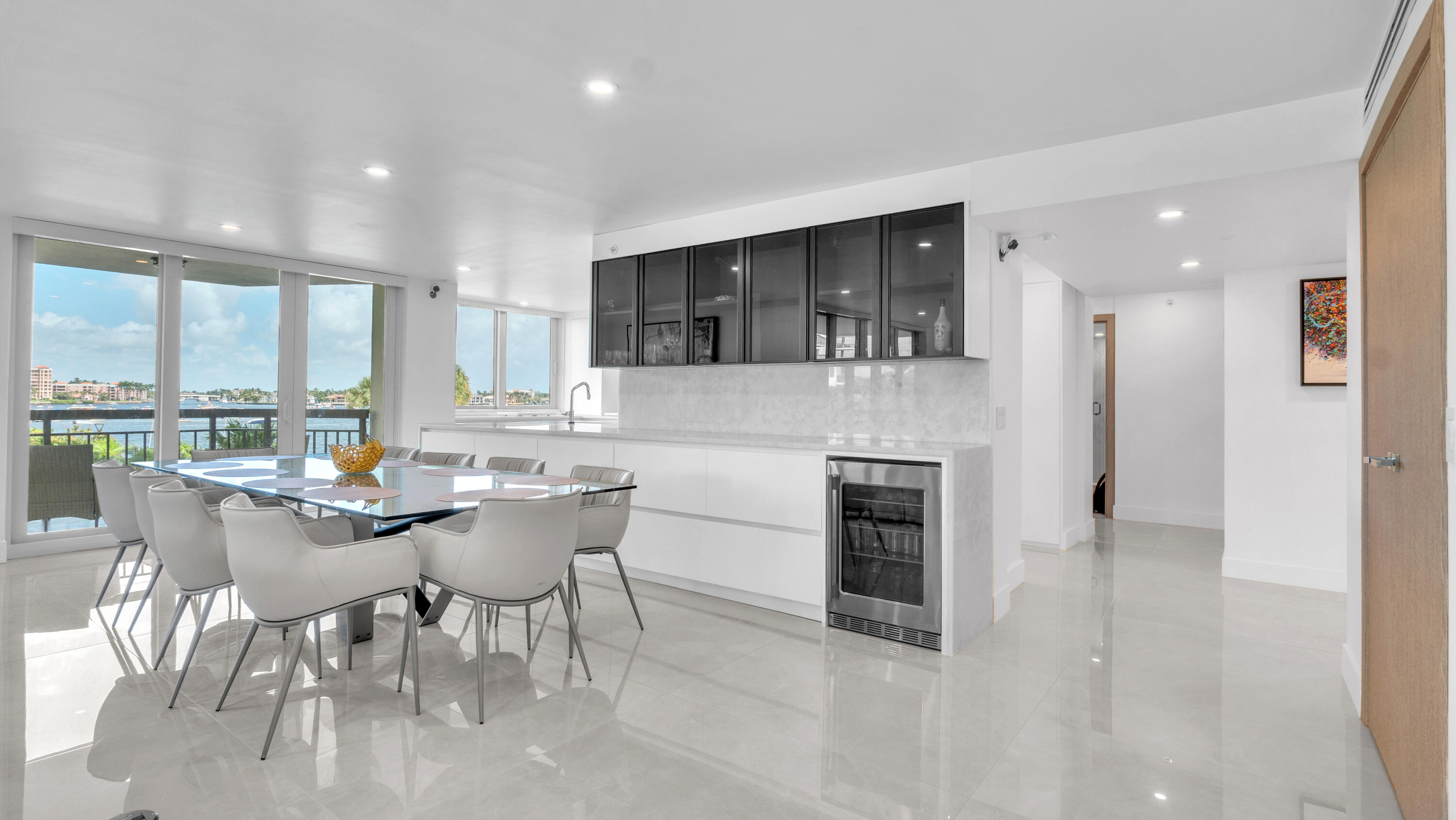 Step into refined elegance with this fully renovated waterfront condo offering sweeping views of Lake Boca. Every detail of this 2,430 sq. ft. residence was meticulously crafted using premium materials imported from Italy. Highlights include 48-inch porcelain tiles, white oak chevron floors, marble countertops, and a custom kitchen with Thermador appliances and a hidden coffee station. All doors, trim, fixtures, and built-ins are custom-designed, with impact glass and motorized blackout shades throughout. The Carlton features a newly updated lobby, 24-hour doorman, fitness center, pool, and Pickleball & Tennis Courts are Coming Soon as well as a dockside BBQ and Outdoor Kitchen! This is a prime location just steps from the beach and the World Famous Boca Raton Resort & Golf Club.
