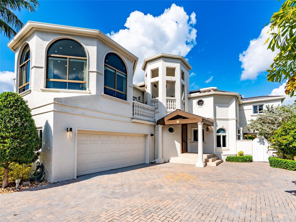 Iconic gated waterfront estate just three homes from the Intracoastal. 65' of deep-water frontage & parking for up to 12 cars. Built in 1990 & extensively remodeled throughout 2020s. Offered fully furnished. Expansive living spaces w/ soaring ceilings, large windows, & sun-filled interiors, including stunning solarium showcasing beautiful bay views. Multiple terraces capture sweeping vistas of bay, canal, & Intracoastal. Resort-style amenities incld pool/spa, & generous entertaining areas ideal for hosting large gatherings. Separate captain's or guest quarters. Every major component has been recently updated, including a 2022 metal roof, 2025 cement seawall, & A/C systems. Rare chance to own a premier waterfront mansion at this price w/ no renovations required.