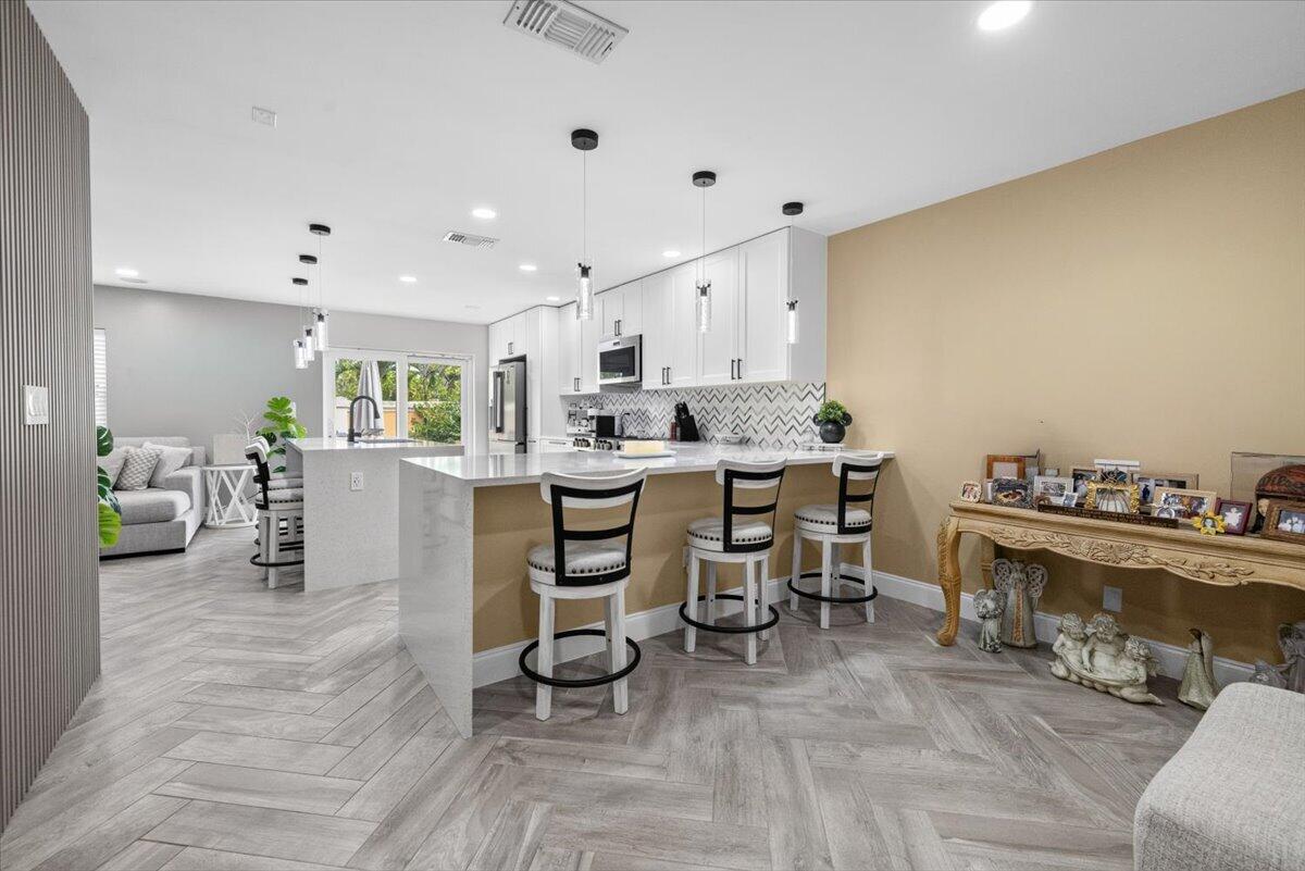 Welcome to this newly renovated, new kitchen, top of the line appliances, beuatifully laid on diagonal ceramic tile floors. Amazing three-bedroom, two-and-a-half-bath residence nestled in Liberty Bay, West Palm Beach. This two-story single-family home offers 1,478 square feet of thoughtfully designed living space, providing comfortable quarters for everyday living and entertaining. The layout includes three generously proportioned bedrooms and 2.5 bathrooms, ensuring convenience for household members and guests alike. A single-car garage provides secure parking and storage for your vehicles and belongings. Located in the Liberty Bay community, this property presents an excellent opportunity for those seeking a well-proportioned home in 24 hour manned gated community in West Palm Beach.