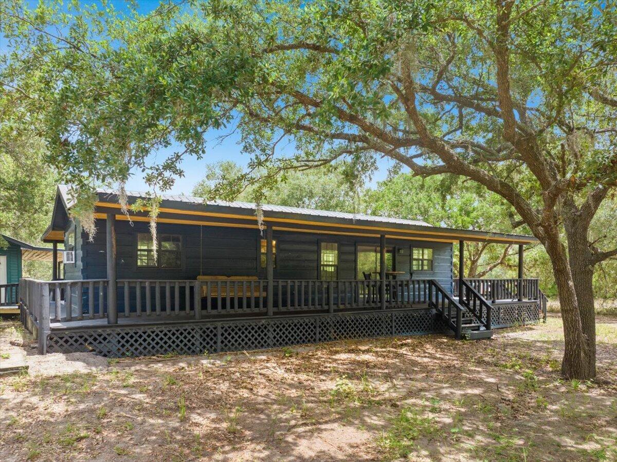 Located near the River Ranch area of eastern Polk County, this unique 2.32 acre property offers a peaceful Old Florida setting surrounded by more than 30 mature oak trees. The property features two cabins, making it ideal as a getaway, weekend retreat, hunting camp, or potential short term rental opportunity.  Enjoy the privacy and natural beauty of this secluded setting while still being within reach of the outdoor recreation, trails, and attractions that make the River Ranch area so popular. Recent roof restoration has been completed, including replacement fasteners, cleaning, protective coating, painting, and resealing.  Whether you're looking for a private escape, recreational property, or investment opportunity, this property offers endless possibilities in the heart of Florida