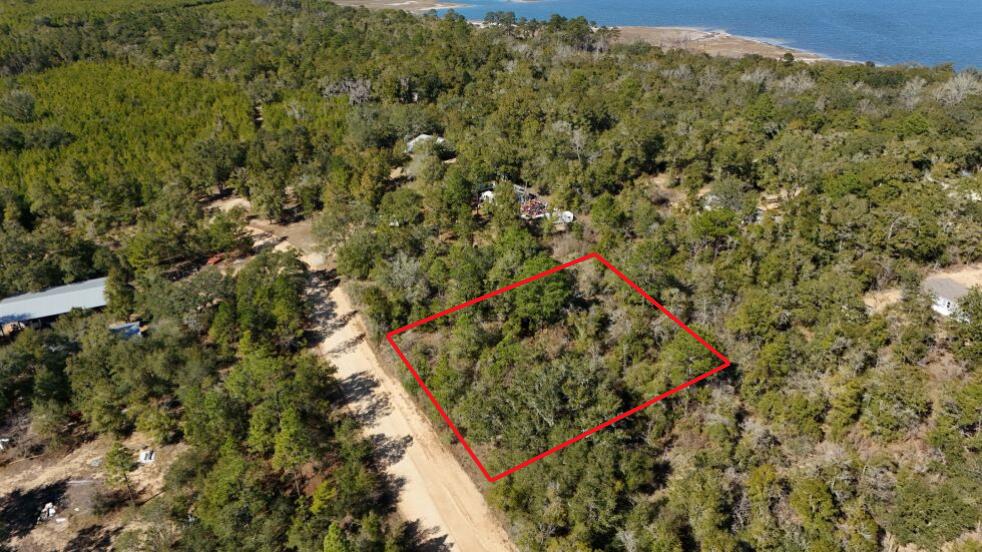 Seize the opportunity to own this pristine 1.01-acre wooded lot in a non-HOA community in Chipley. This high-and-dry land, zoned RL for Residential, opens the door to countless off-the-grid building possibilities. Enjoy direct road access via a county-maintained dirt road, making it easy to develop your dream home or getaway retreat. Imagine building a charming single-family home, a mobile home, a cozy tiny home, or a lucrative short-term vacation rental. You can even bring in a mobile home! Please note that some RV restrictions apply; please review the attached documents for details. Well and septic systems are required. Power poles on the road; lines would need to be run, or an alternative power source used, which will add to the property's self-sufficient charm. Situated only an hour from the vibrant cities of Destin and Panama City Beach, this location offers the best of both worlds' peaceful seclusion and urban conveniences. Plus, you'll be just minutes away from exciting attractions, including Cypress Springs and Morrison Springs County Park. Don't miss out on this incredible opportunity to create your own slice of paradise!